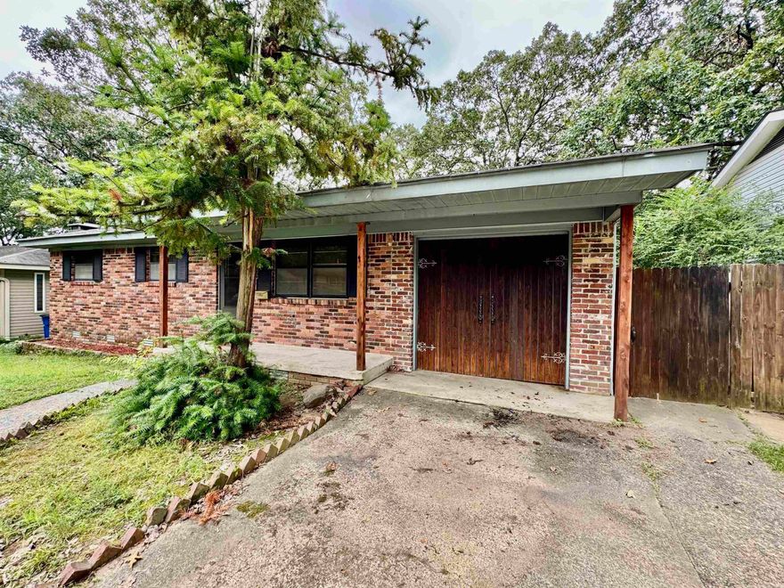 Looking for something Unique! This house is it! The fireplace in this house makes it one of a kind. This well maintained home has 3bd 2ba plus an extra living room and sunroom area. Original hardwood flooring in extra living rm, hallway and all bedrooms. New HVAC and duct work in (2022), Kitchen has new countertops 2022. Nice fenced in back yard with a 16 x 20 storage building. House is move in Ready. The garage could be turned back into a one car garage. New roof (February 2025). See agent remarks!