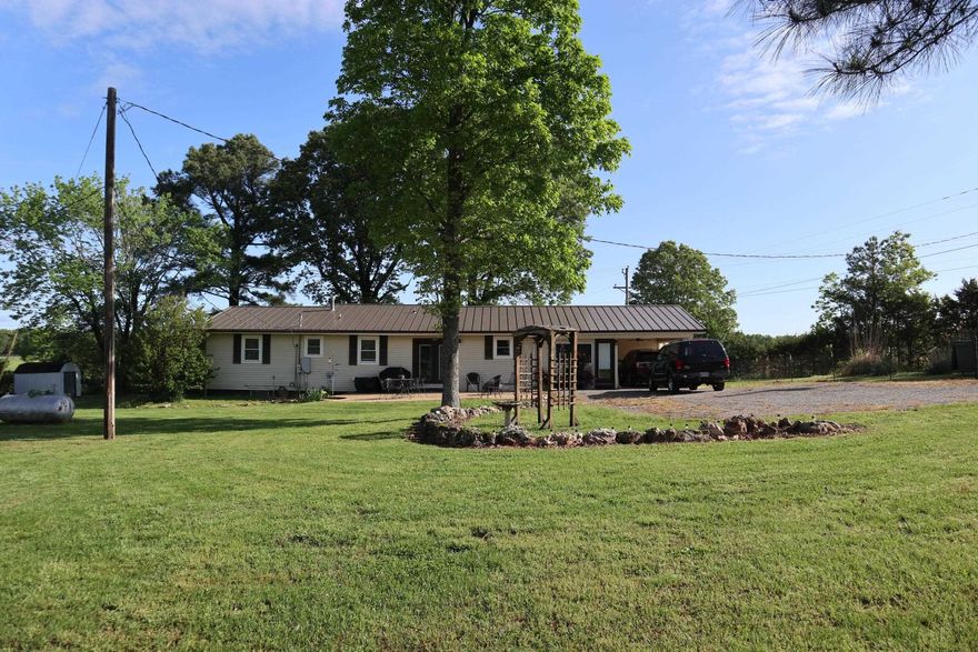 HOBBY FARM AND COUNTRY HOME FOR SALE AGNOS ARKANSAS  ?Property is located at 115 Indian Trail Rd, Agnos, Arkansas. Great location, only 1/10 mile off of Hwy. 62/412.  Country home sitting on 2.76 acres. 3 bedroom, 2 bath home with approx. 1,326 sq. ft. of living area and a 1 car carport. Additional room that could be used as an office area or bedroom space. Also includes a partial unfinished basement. It has central heat & air, refrigerator, range, microwave and dishwasher. Gas fireplace, gas wall heater, attic fan, vinyl flooring,  portable generator and a 250 gallon propane tank. Several large shade trees, plenty of space for a garden, rural water, well, private septic system. Large concrete patio to enjoy your cookouts. Beautifully landscaped yard with several flowers and shrubs. Shop/barn building and storage building. The property is fenced and cross fenced. This property is ideal for your hobby farm. Ideal for horses, cattle, goat & sheep. Last year real estate taxes - $658.80.  Make your move to the Ozarks on this self sufficient property.