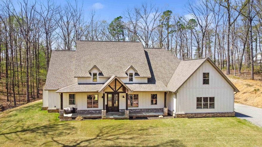 Overlooking a creek and wildlife, this breathtaking modern farmhouse offers rustic charm and contemporary luxury. Enjoy the peaceful views from the porch, then step inside to a grand vaulted living room with rustic wood beams and a brick-accented fireplace, island, and backsplash. The chef’s kitchen is a dream, featuring a commercial-grade fridge, gas stove, oversized island, & sink overlooking the private backyard—all surrounded by ample granite countertops. And don’t miss the massive walk-in pantry, practically a room of its own! The split floor plan offers privacy, with two spacious bedrooms & full bath on one side, while the primary suite steals the show with its vaulted ceilings, wood beams, and spa-like bathroom. Enjoy a luxurious walk-in shower with rain head, hand wand, and body jets, a soaking tub, split vanities with a makeup counter. The walk-in closet has a built-in dresser that seamlessly connects to the laundry room. Above the 3-car garage, you'll find a great size 4th bedroom/bonus room with its own closet & full bathroom—perfect for guests, a media room, or a private retreat. Second drive and planned shop space connects to this private 8+ acre oasis, a rare find.