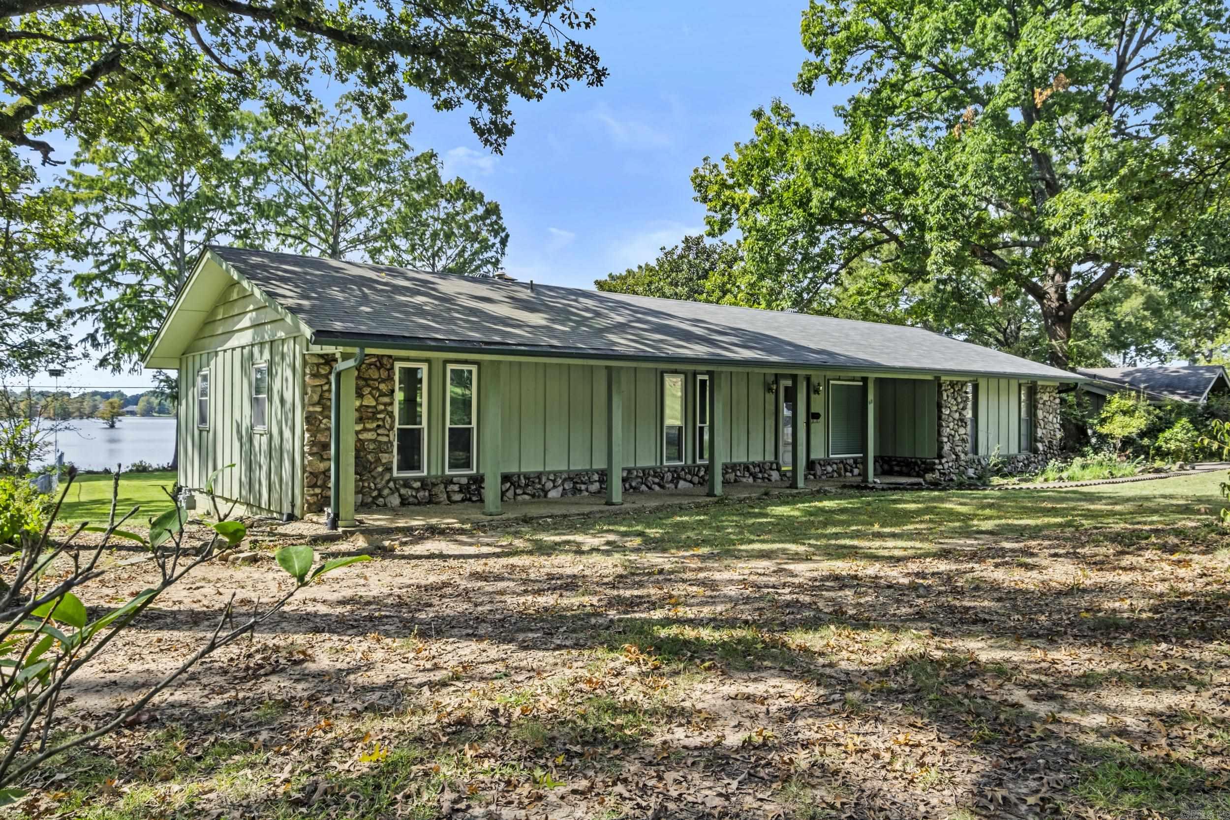 Wake up every day to breathtaking lake views in this 3 bedroom/2 bath home nestled on a serene waterfront lot. This property boasts a spacious sunroom perfect for relaxing or entertaining while enjoying the scenery year-round. Inside you will find a cozy rock fireplace in the living area, adding rustic charm and warmth. There is endless potential for you to add your personal touch and modern updates. Additional features include a 2 car garage, RV parking with full hookup, and plenty of outdoor space to enjoy lake life all within minutes of the Little Rock Air Force Base. Check this home out today.