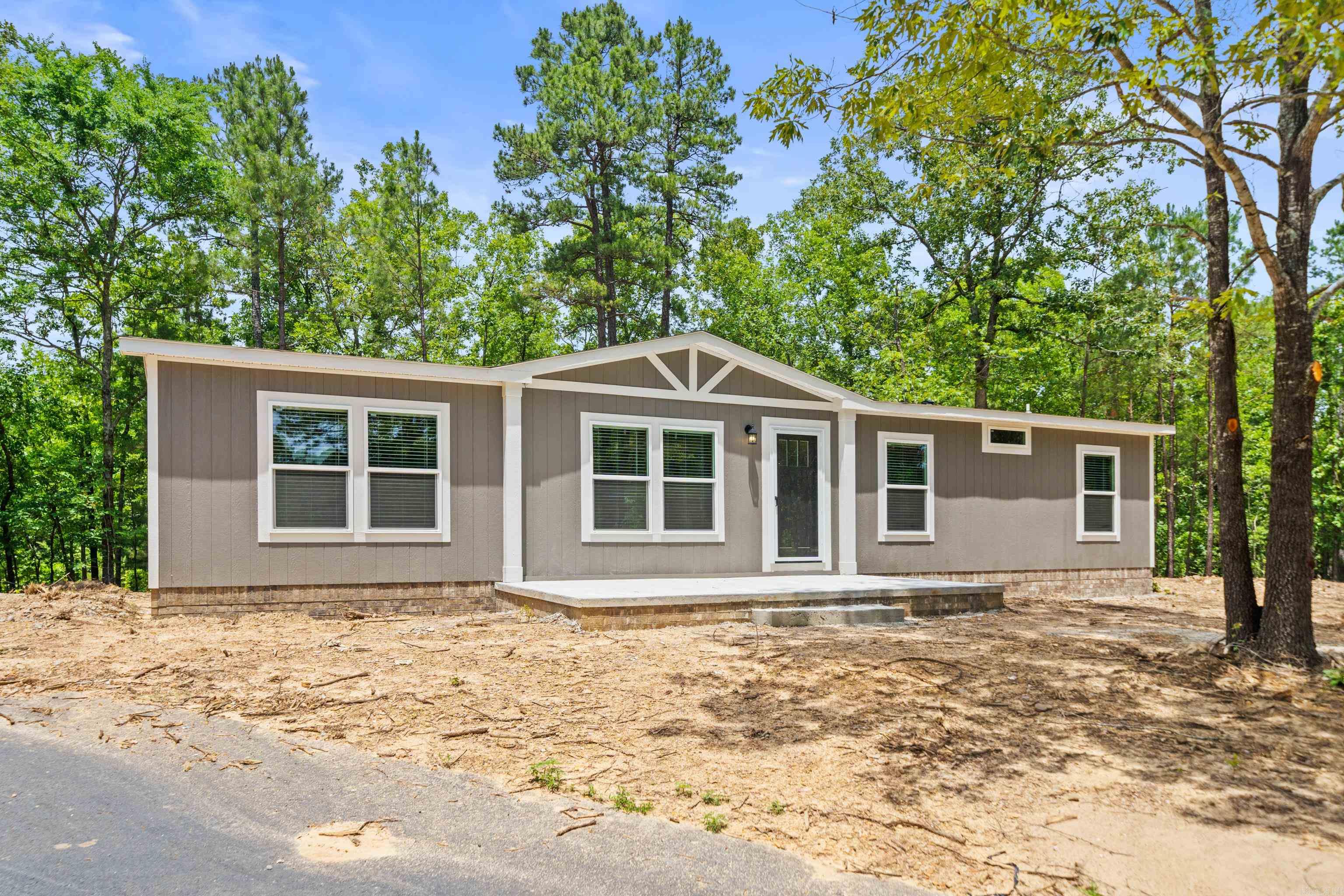 BRAND NEW 2025 CLAYTON HOME!!! siting on your own lovely 1.3 acre lot! Smart Panel exterior siding w a 50-year warranty! Five-year warranty on the HVAC. Spacious kitchen with Island and Samsung Stainless appliances, range, dishwasher, microwave, and refrigerator. Tiled shower in the master bath with a separate soaking tub to relax and enjoy after a long day!! There will be beautiful brick around the perimeter, this will be a very nice Home with paved drive!!! Lovely setting with mature trees and private!! Mountain ridge view in the distance! You will not find another home at this price with all the bells and whistles at this !! Hurry to make your offer and its move in ready!!
