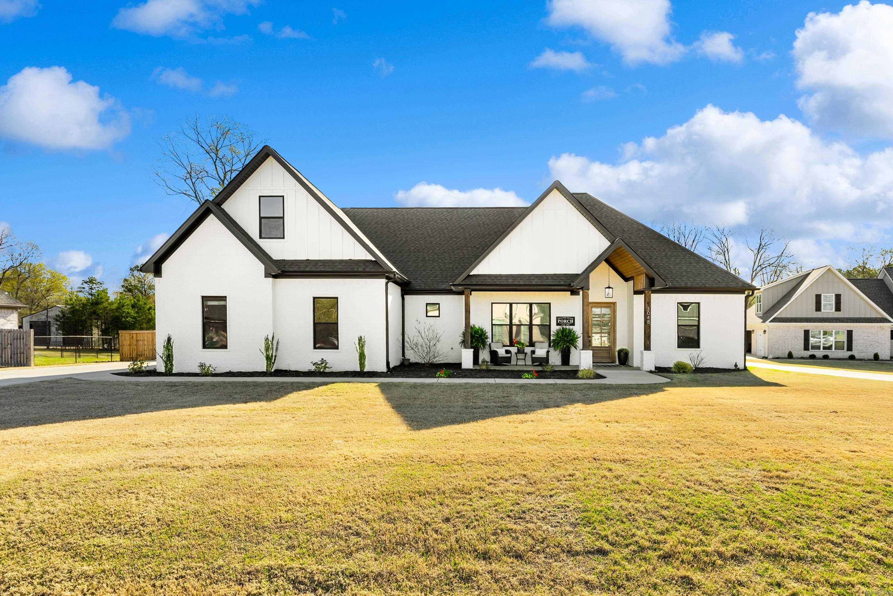 Welcome to this like-new custom-built masterpiece, where modern elegance meets rustic charm! Nestled on a fully fenced, one-acre lot, this 4-bedroom, 3-bath home offers exquisite design throughout. Immediately greeted with shiplap-accented walls in a rich succulent green, perfectly complemented by stately wood beams and a grand stone fireplace—the heart of the living space. The open-concept layout flows seamlessly into the spacious kitchen, complete with granite countertops, an oversized island, a walk-in pantry, and a dedicated office area for your work-from-home needs. The primary suite is a private retreat, featuring an elegant spa-like bathroom with a pass-through shower, split vanities, a soaker tub, and a makeup counter. The large walk-in closet conveniently connects to the laundry room, ensuring effortless organization. Outside, enjoy the covered patio overlooking the fenced in yard, with a built-in fireplace. Sprinkler system added to make maintenance a breeze. The three-car garage provides space for vehicles, storage, or a workshop. Bryant school district, natural gas, fiber internet and a private yet vibrant cul-de-sac filled with neighborhood events.