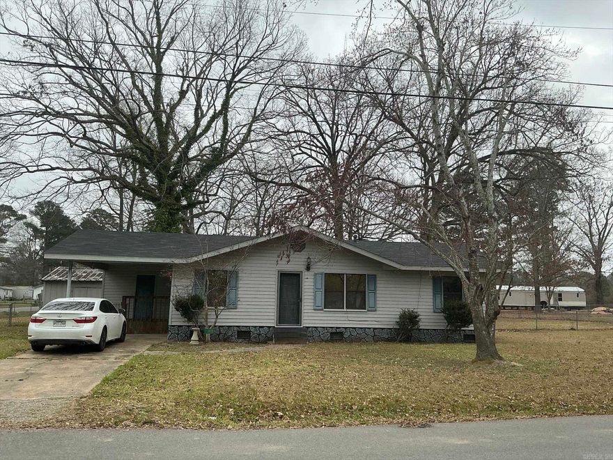 If you are looking for a Move-in-Ready, great starter home, or a great home to retire to, this is the home for you.  It features a galley kitchen with stove and open to the dining area.  The living room is also open to the dining room, and the hall leads to the 3 bedrooms and hall bath featuring shower over the bathtub.  The laundry room is located in laundry room off the one car carport.  Home is all electric and has central unit with new thermostat, and the roof was replaced December 2025.   If you are looking for a large fenced in yard for a garden, this home is for you and is located on a corner lot with double gates for easy access to the backyard.  Seller has also left some furniture and a clothes dryer that will remain with the property if buyer wants them. (Seller is selling "as is")  House will qualify for FHA and USDA-RD.