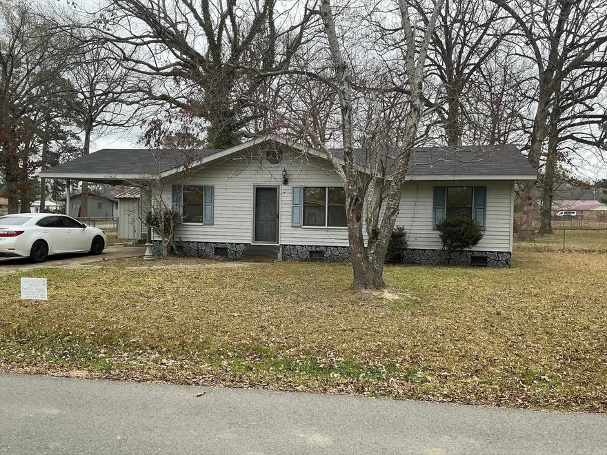 If you are looking for a Move-in-Ready, great starter home, or a great home to retire to, this is the home for you.  It features a galley kitchen with stove and open to the dining area.  The living room is also open to the dining room, and the hall leads to the 3 bedrooms and hall bath featuring shower over the bathtub.  The laundry room is located in laundry room off the one car carport.  Home is all electric and has central unit with new thermostat, and the roof was replaced December 2025.   If you are looking for a large fenced in yard for a garden, this home is for you and is located on a corner lot with double gates for easy access to the backyard.  Seller has also left some furniture and a clothes dryer that will remain with the property if buyer wants them. (Seller is selling "as is")  House will qualify for FHA and USDA-RD.