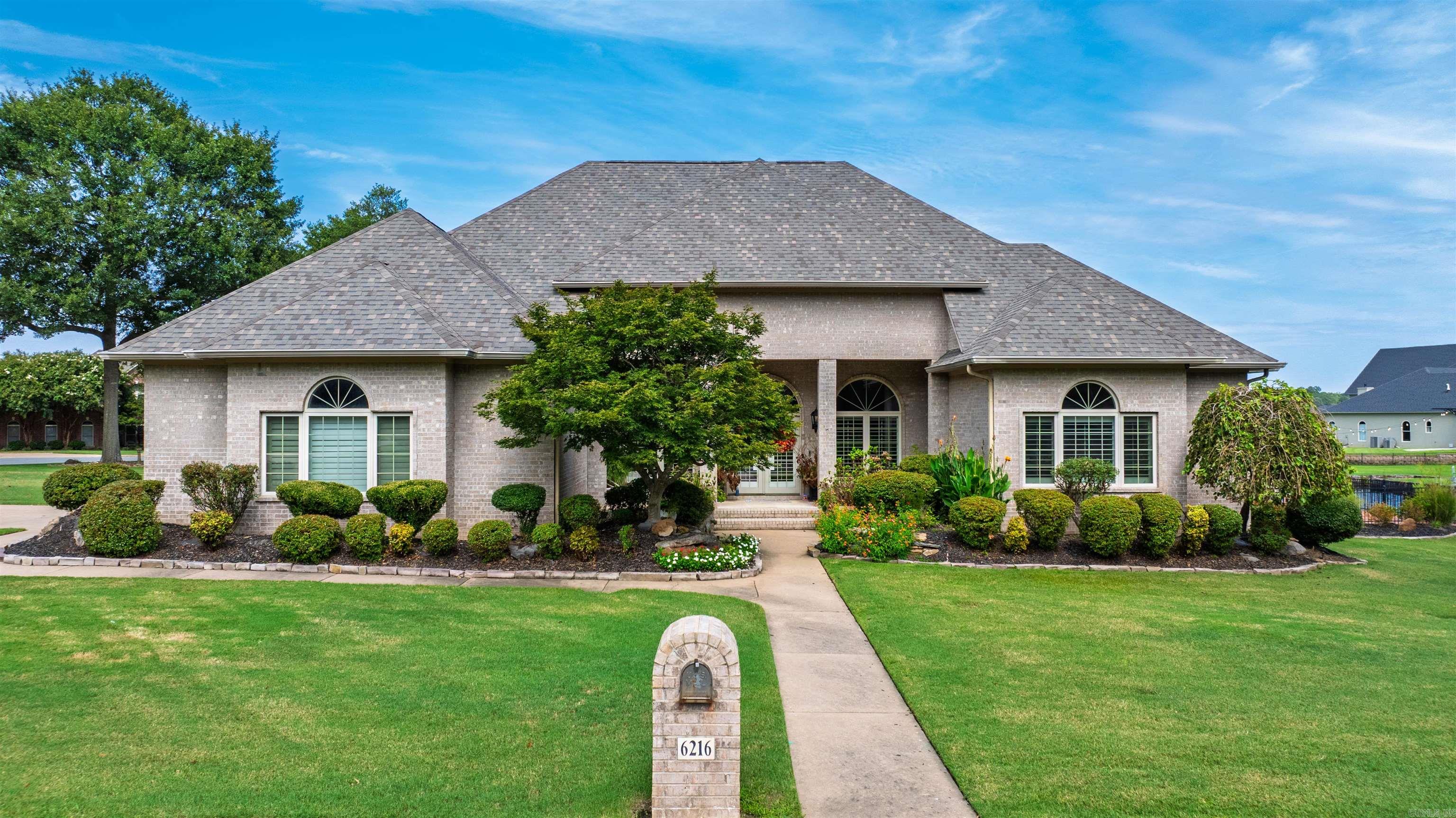 Discover this stunning lakefront home where luxury meets tranquility. Nestled in one of Saline County's most sought-after neighborhoods on a desirable corner lot, this beautifully decorated home offers breathtaking views of the water from nearly every room. Step into the living area which features high ceilings, a wall of windows overlooking the lake and elegant finishes throughout. The spacious living room flows seamlessly into an updated kitchen complete with a huge island perfect for entertaining. The kitchen also includes a formal dining area complete with a hearth area with a gas fireplace. The dedicated home office provides a perfect space for remote work or studying. The primary suite is a luxurious escape with a spa-like bathroom, his/her closets, gas fireplace and access to the amazing backyard. When you step outside to the huge patio, you will find a gorgeous pool (with a new liner) overlooking the lake which is perfect for hosting guests or unwinding after a long day. Don't miss your chance to own a rare lakefront gem---schedule your private showing today! AGENTS SEE REMARKS