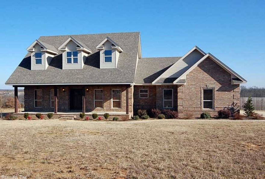 Beautiful like new home sitting on large 3.91 acre lot with beautiful views and large covered front porch.  Home features high end finishes and lots of crown molding.  Open living/kitchen combo, custom kitchen with stained cabinets, granite counter tops, and lots of trim.   Living room features a double sided beautiful gas rock fireplace to sunroom off living room with.  All beds are good size.  Master is large, bathroom has jetted tub, walk in tiled shower and safe room. Large extended back deck. Look now!