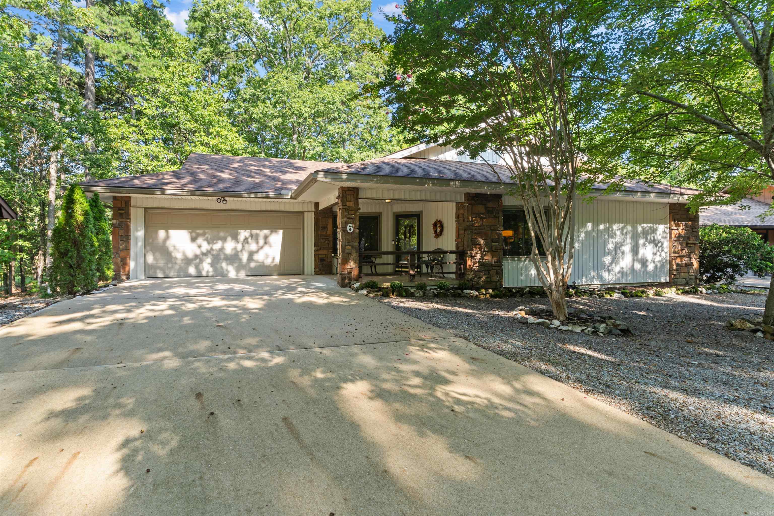 Conveniently located just one minute from the West Gate of Hot Springs Village, this 3-bedroom, 2-bathroom home offers 1,752 sq. ft. of well-designed living space. The open floor plan highlights a cozy gas log fireplace, natural lighting and LVP flooring throughout, creating both warmth and style. The remodeled kitchen (2017) features granite countertops, updated cabinetry with pull-out shelving, and under-cabinet lightingāperfect for everyday living and entertaining. Both bathrooms have also been tastefully remodeled. Enjoy the outdoors year-round from the large screened-in back porch overlooking the natural scenery. Additional updates include a new roof (2019) and gutters (2021). A spacious two-car garage with a recently added storage room provides extra convenience. Situated on a level lot and meticulously maintained, this home is move-in ready and combines modern updates with comfort in a prime location. First time HSV property owners are subject to one-time $2000 buy-in fee.