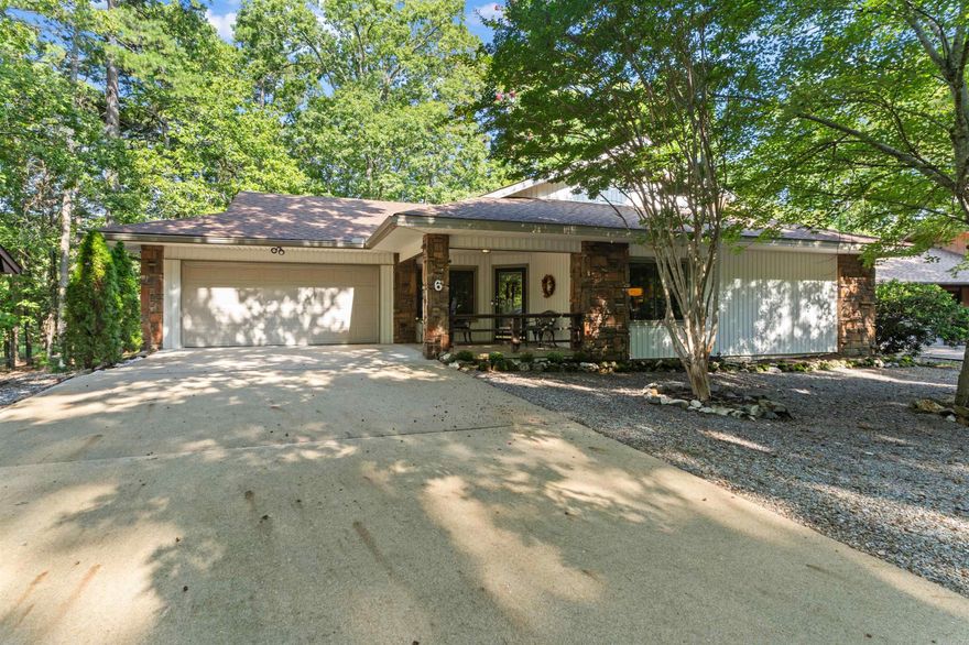 Conveniently located just one minute from the West Gate of Hot Springs Village, this 3-bedroom, 2-bathroom home offers 1,752 sq. ft. of well-designed living space. The open floor plan highlights a cozy gas log fireplace, natural lighting and LVP flooring throughout, creating both warmth and style. The remodeled kitchen (2017) features granite countertops, updated cabinetry with pull-out shelving, and under-cabinet lighting—perfect for everyday living and entertaining. Both bathrooms have also been tastefully remodeled. Enjoy the outdoors year-round from the large screened-in back porch overlooking the natural scenery. Additional updates include a new roof (2019) and gutters (2021). A spacious two-car garage with a recently added storage room provides extra convenience. Situated on a level lot and meticulously maintained, this home is move-in ready and combines modern updates with comfort in a prime location. First time HSV property owners are subject to one-time $2000 buy-in fee.