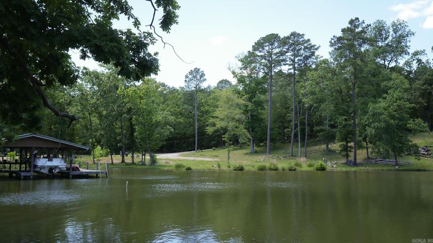 129 Ft of Lake Hamilton Waterfront | Build-Ready .75-Acre Lot | Hot Springs, AR  Rare opportunity to own 129 linear feet of pristine Lake Hamilton frontage on a beautiful 0.75-acre lot in Hot Springs, Arkansas. This cleared, build-ready parcel features a gorgeous mix of mature trees and open space — the perfect canvas for your custom lake home, weekend retreat, or vacation rental investment.  The hard work is done: working septic, electric at the lot, fiber optic internet on property, and public water available at the street. Bring your builder and your blueprints.  Lake Hamilton is central Arkansas's premier recreational lake — world-class bass fishing, waterfront dining, boating, and tubing. Minutes from Oaklawn, Hot Springs National Park, and Central Ave dining and shopping. Host of 2026 World Bass Fishing Championships.  Located in the highly regarded Lake Hamilton School District.  Additional lots available — ask about the full package of three.  Buyer retains mineral rights. New construction only — no trailers, mobile, or modular homes. No RV restrictions, no time limit on RV stays — bring your RV and enjoy lake life while you plan and build your dream home.