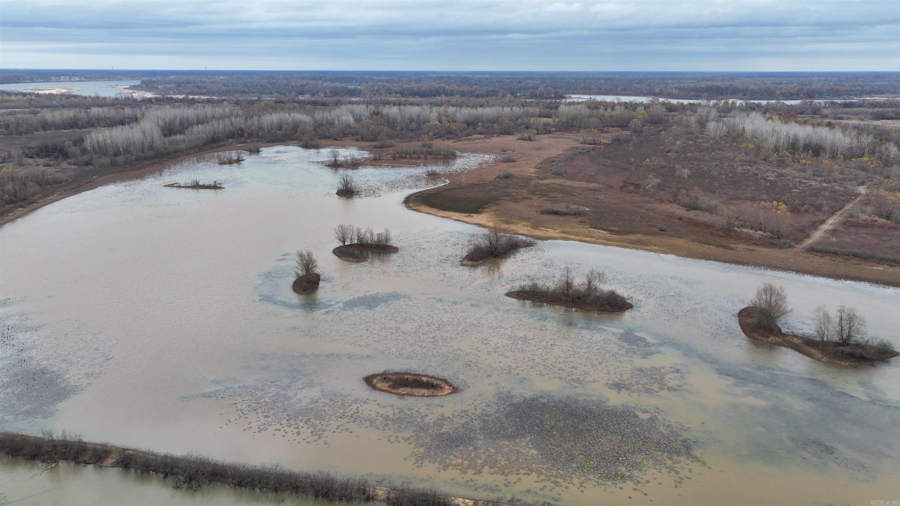 Entry Only: Krovest Plantation is 2348+/- acres located along the western side of the Arkansas River. Property was mostly enrolled into WRP and consisted of planted oak trees and moist soil units. Land had wells and a shop but generally was unimproved for hunting.