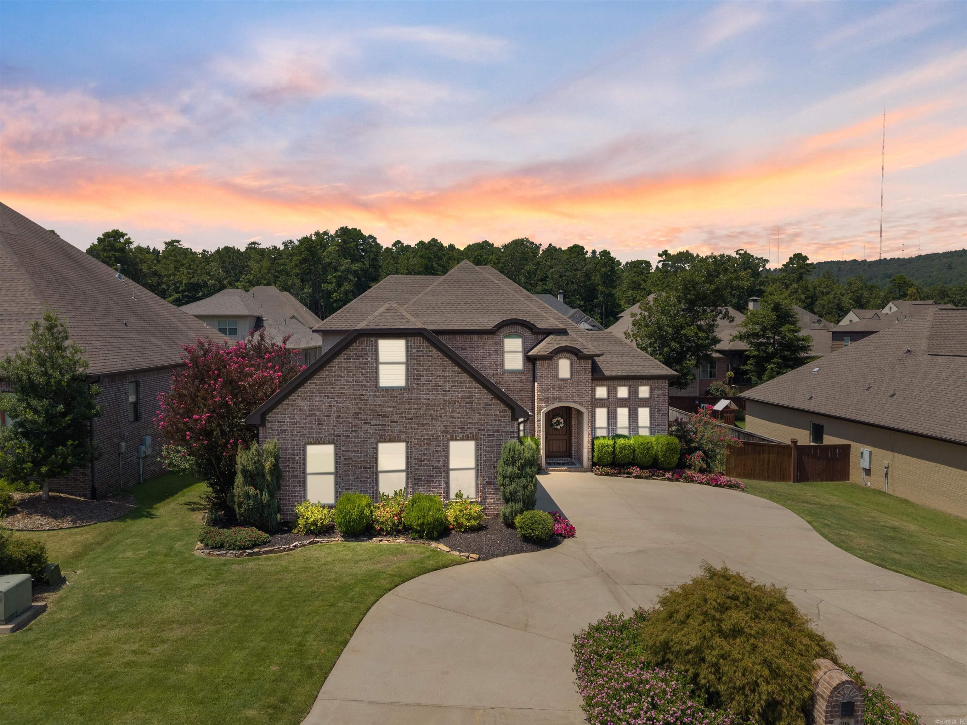 Welcome to 408 Miramar Blvd, located in Chenal Valley with golf cart access to the Chenal Country Club and Golf Course. This classic brick home offers timeless curb appeal and convenienceājust minutes from dining and shopping. A circular drive welcomes you into a gracious two-story foyer with hardwood floors. The office features French doors, 12-ft ceilings and beautiful custom windows adjacent to the formal living room (or dining room) with access to the kitchen. The kitchen was designed for preparing family meals with granite countertops, a gas cooktop, wall oven, large island with bar stool seating, and a walk-in pantry. The kitchen is open to the breakfast area and spacious great room with a gas log fireplace and surround sound. The main-level primary suite is a retreat with a spa-like bathroom including his-and-her vanities with makeup area, soak tub, shower and a spacious walk-in closet. Upstairs features two bedrooms, a full bathroom, and a game room/flex space that could serve as a 4th bedroom. Outdoor living includes a covered patio with wood-burning fireplace, deck, and fenced yard. A new roof will be installed by the seller, offering peace of mind for the new homeowner.