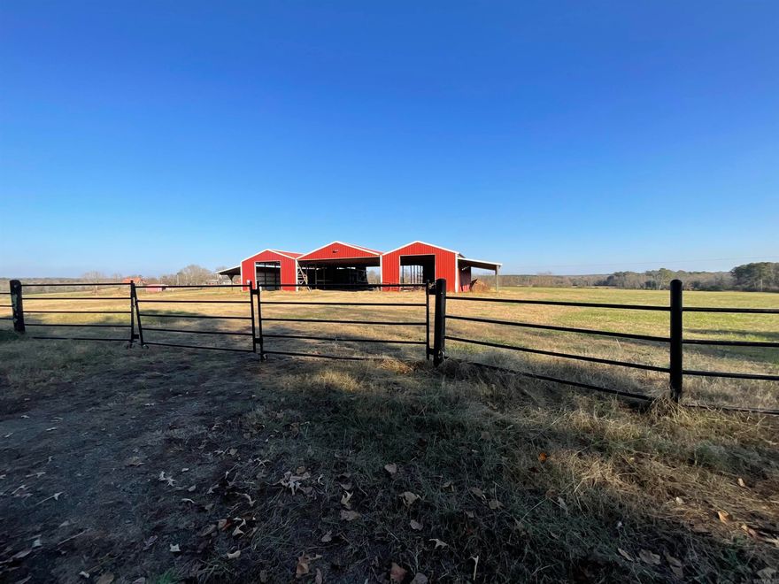 PRIME property overlooking the Ozark Mountains! 31.47 acres of beautiful hay farm with a huge 130'x80' wood truss hay barn! The concrete is 100'x80' with two 15' overhang sheds on either side. Pipe fence surrounds entire property. Small pond to the side and irrigation present! Would be a beautiful homestead location or a great income property! SEE AGENT REMARKS  Farm across the road is also for sale: see MLS# Mineral rights do not convey.