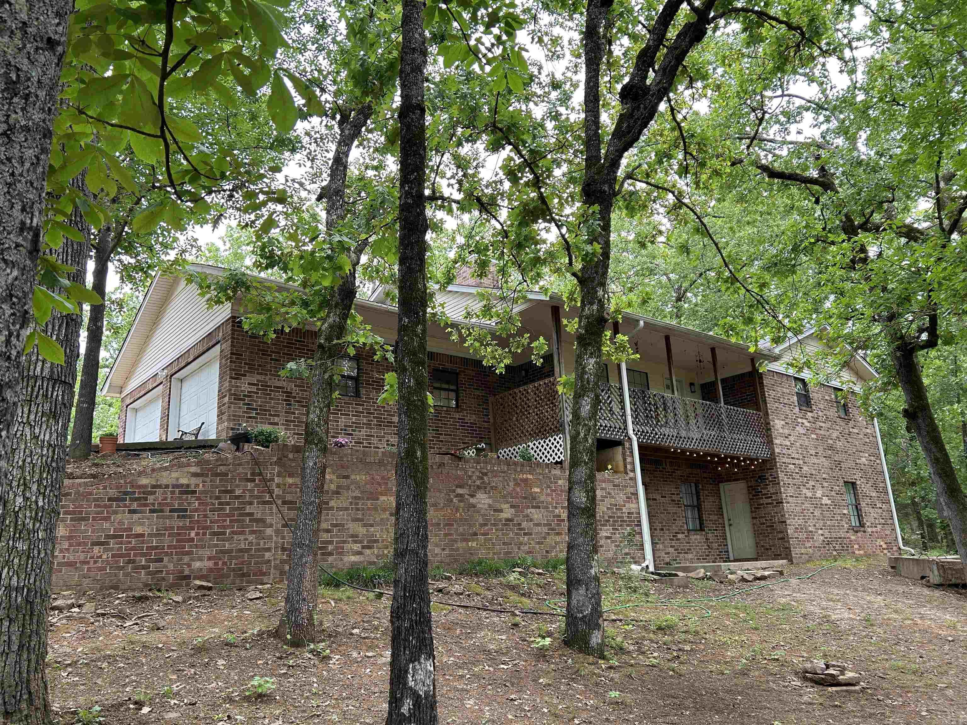 This is a slice of secluded paradise! 3 quiet, wooded acres, featuring a detached garage/shop, an additional 50 x 50 metal building, with a great home as the cherry on top! Don't miss the cozy sunroom, or the versatile bonus room downstairs - den, movie room, game room, bedroom... endless possibilities! Sit up on your porch and watch the deer move around the front yard.