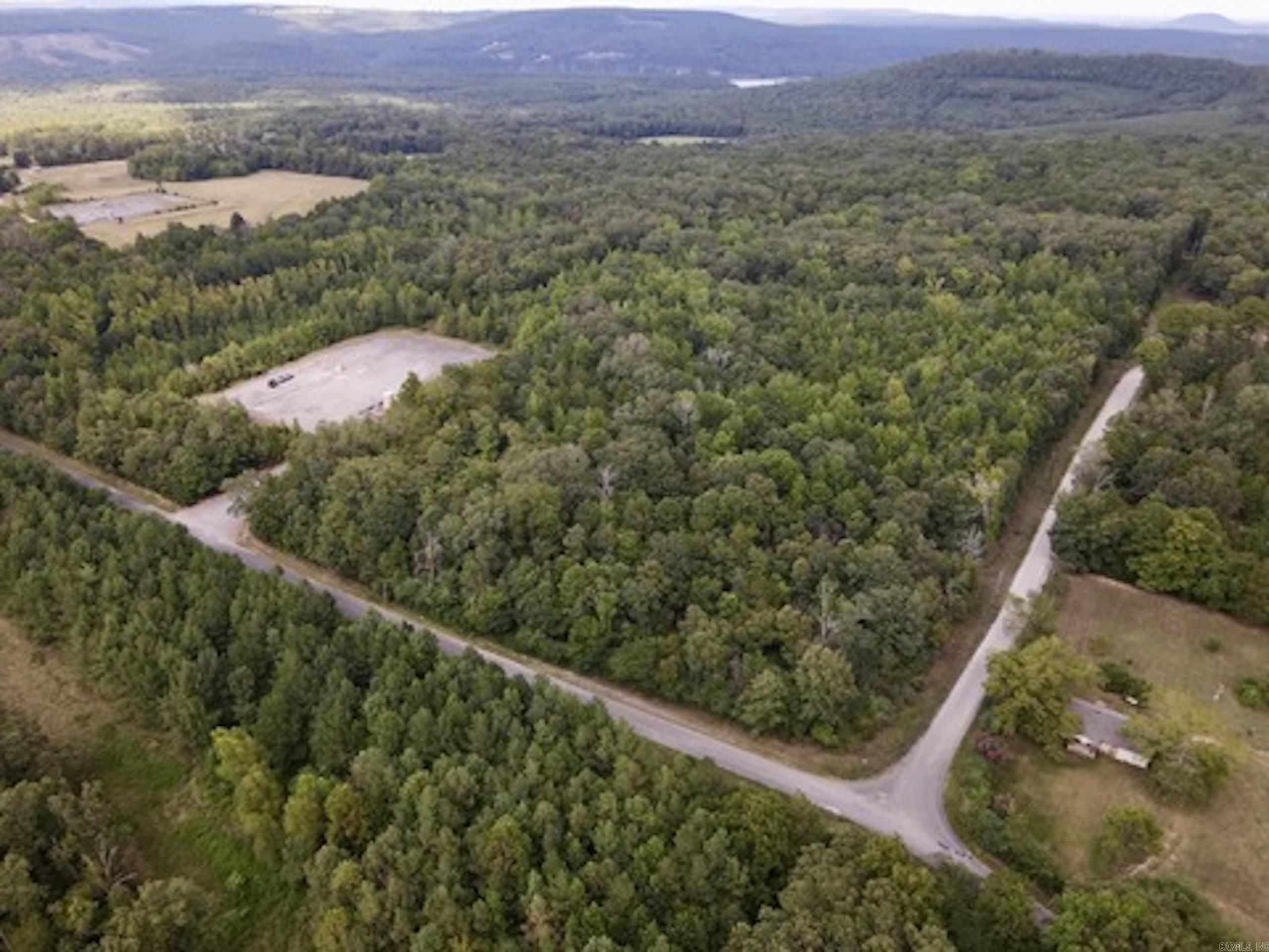 Tucked in the rolling hills of the Ozark Mountains and just minutes from the sparkling waters of Greers Ferry Lake, this property offers a rare blend of convenience, natural beauty, and development potential. With county road frontage on two sides, access is easy and versatile, making it ideal for a variety of uses - from building your dream home to creating a vacation retreat or dividing into smaller parcels.