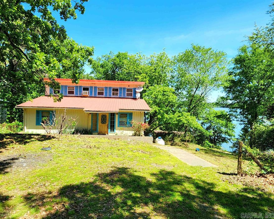 Amazing opportunity with tremendous recreation value and income potential. Sold As-is.  front home located on Harris Brake Lake, the 3rd largest lake owned by the Arkansas Game and Fish Commission and adjacent to 800-acre duck hunting reserve. Easy access to boat ramps. This home could be perfect for multigenerational living, Airbnb, rental, or large family living. This 3-level home has over 3,000 sqft (including basement) Downstairs/basement level has small kitchen area, and dining area. This could potentially be an office/workspace, "in-laws’ quarters" or apartment with more bedrooms and separate entrance. Main Floor has open kitchen with dishwasher, electric range, and refrigerator.  The kitchen is very functional with tons of cabinet space. The dining room has big windows that look out over the deck with beautiful lake views. Spacious living room with a built-in cabinet unit for added storage. The private master bedroom is upstairs on the 3rd level. The master bedroom has a large walk-in closet and spacious bathroom with double sinks.  It becomes a retreat to escape the hassles of daily living. Primary residence, second home or investment. It's a win-win! Call now