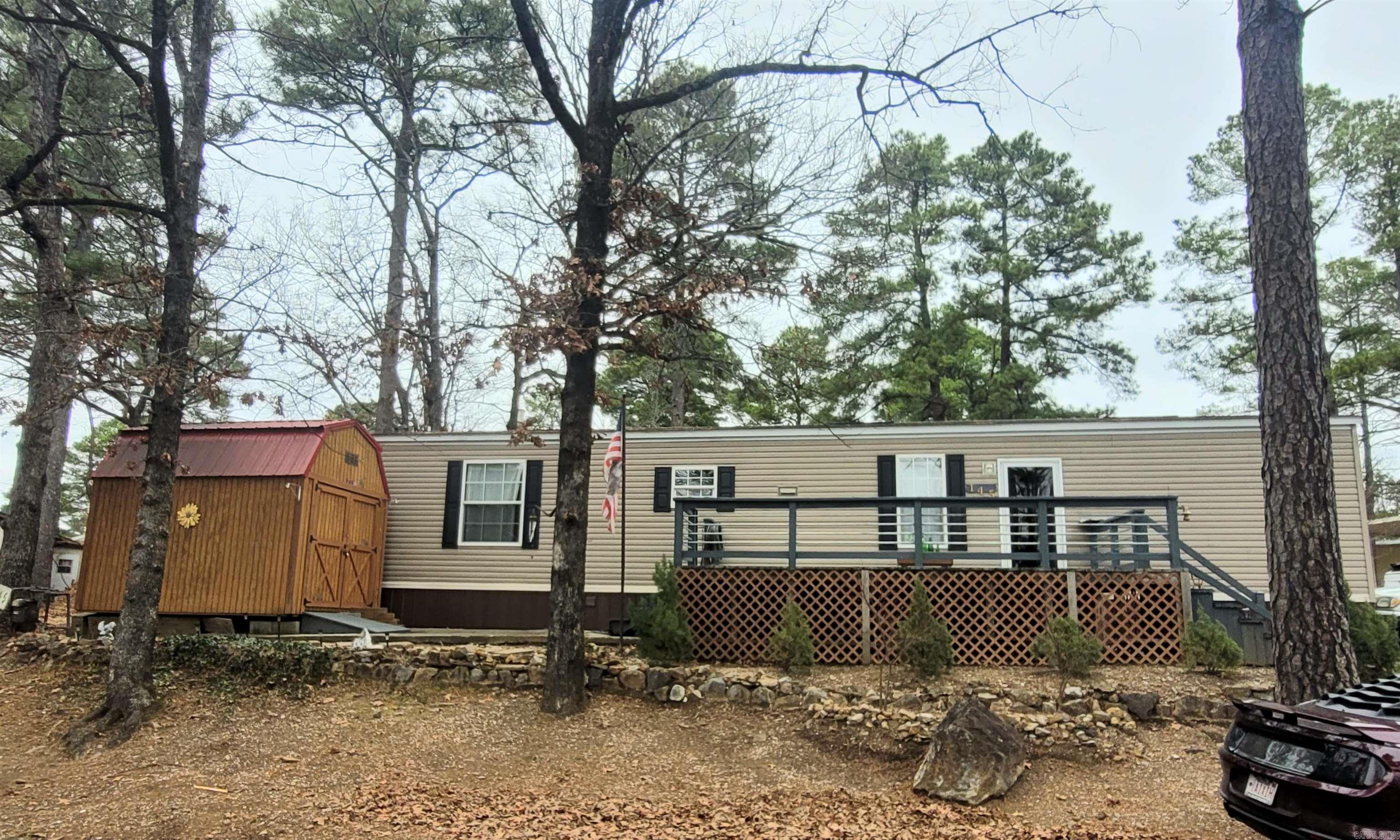 Ready to live where convenience meets comfort? This standout 2014-built 2-bedroom, 2-bath mobile home offers a more modern option in a community where many homes are from decades past. Sits on convenient, quiet corner lot. It's just minutes from Oaklawn and right next to all the shopping and dining you could want! Inside, you'll find central heat and air for year-round comfort, a bright, open layout, and plenty of natural light. The large wooden deck provides space for outdoor living and relaxation. The 8x12 storage building and bonus storage under the deck adds extra room for your needs. The washer (just bought in December), dryer, refrigerator and all furnishings stay. 2003 Ford Ranger included with full price offer! 55+ Community. Land does not convey. Home is on monthly leased land. Don't miss this great opportunity! Schedule your showing today!