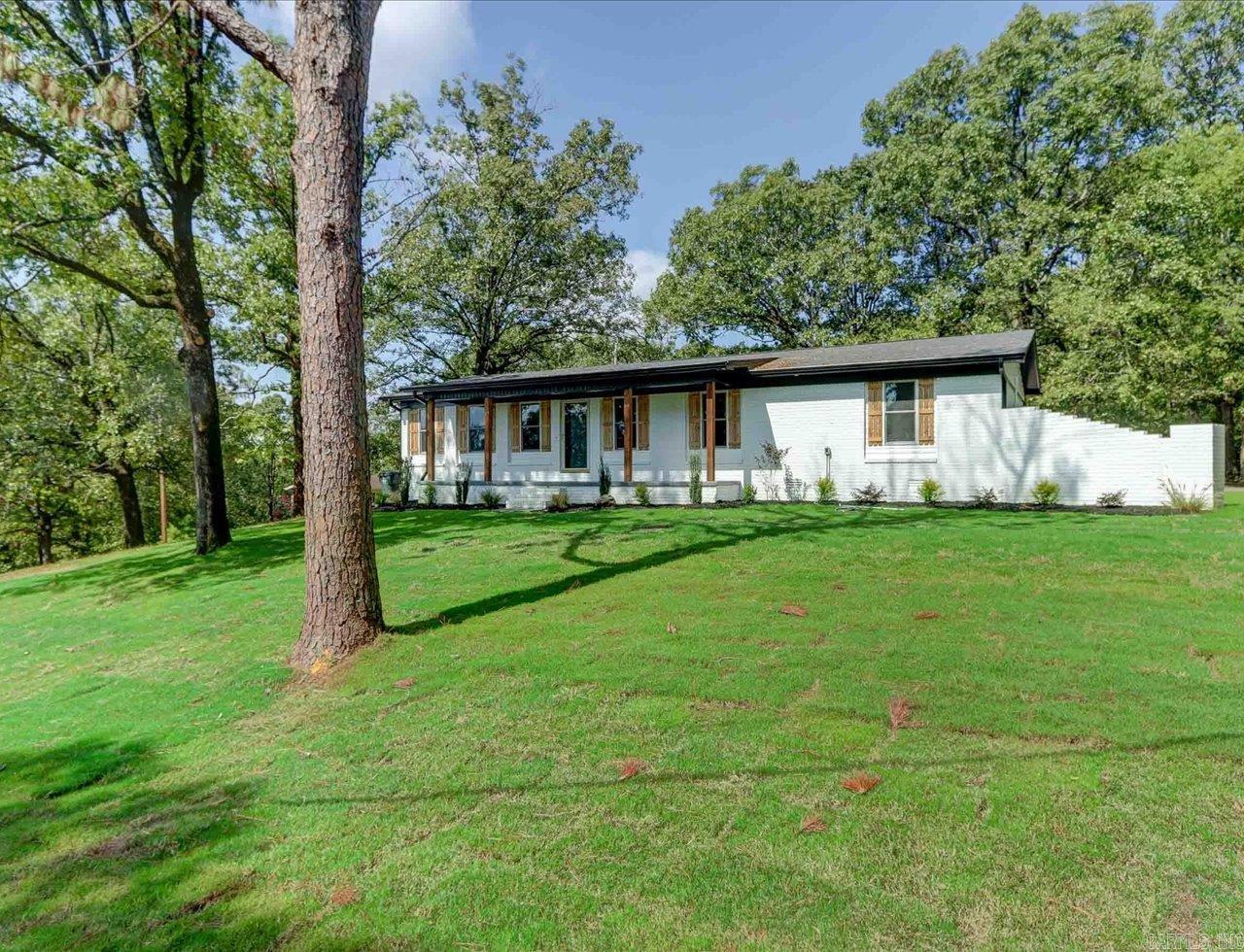 Thoughtfully remodeled from top to bottom! Just like new! Hilltop setting with close to half acre lot in Lake Hamilton School District. Wait until you see this home, it's light and bright, clean, and modern with a craftsman flair curb appeal. Freshly painted all brick exterior with cedar accents. Location is exceptional when shopping, needing medical, or a day on the Lake with boat ramp just minutes away. Out back you will find a large patio and plenty of parking space on your fresh asphalted driveway. Garage is heated and cooled (not included in the square feet) and the garage floor has been painted with metallic flake you will love! Interior has been finished out with all the modern accents with Quartz throughout, black stainless appliances, tiled showers and modern lights! Owner is licensed Real Estate Agent.