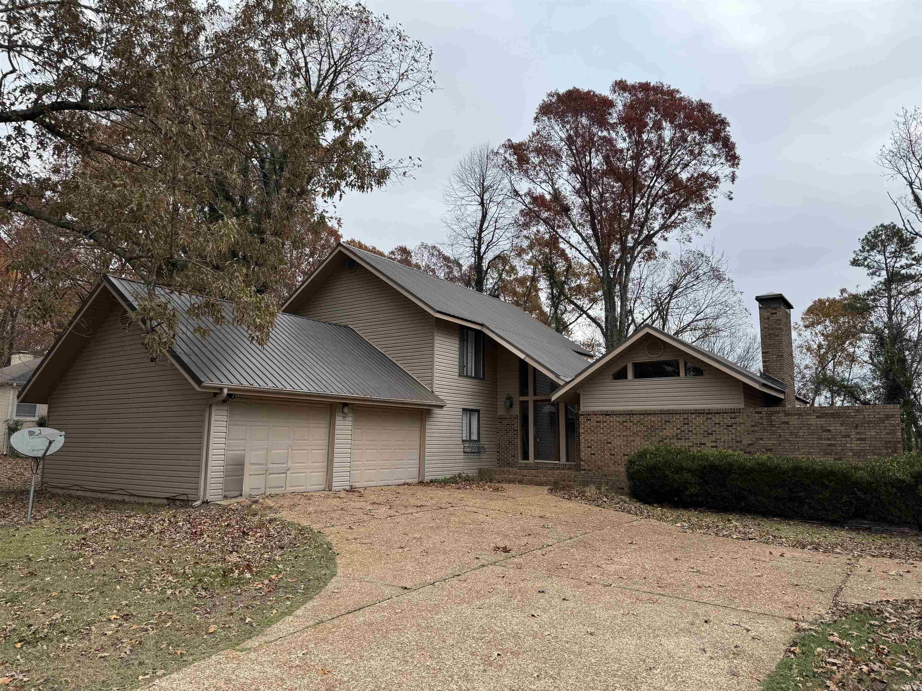 This unique contemporary style home in a wonderful location has loads of personality, plus a new kitchen with new cabinets, fixtures & granite countertops, new flooring downstairs, a living room & den, each with its own gas log fireplace, an in-ground swimming pool & a hot tub. Property comes with TWO lots approximately 1/2 acre each. Back deck facing woods makes you feel like you are living in the country, yet has the convenience of town.