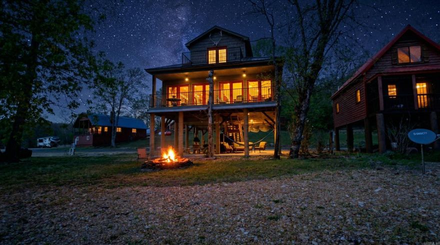 Spring River Riverfront Retreat with Private Access & Luxury Living  Enjoy direct access to the water from your own lot, complete with a private gravel shoreline perfect for fishing, swimming, or relaxing. The home features a full-width covered deck overlooking the river and a shaded patio below for additional outdoor space and storage for kayaks and river gear. Elevated on concrete piers, it is designed for protection during high water.  This 1,524 sq ft, two-story home sits on a 0.31-acre lot and offers 3 bedrooms and 2.5 bathrooms. The main level includes a master suite with a soaker tub and tiled shower, along with the kitchen, dining, living area, and half bath with laundry. Upstairs features two bedrooms and a full bath. The kitchen includes granite countertops, custom cabinetry, and stainless steel appliances. Additional features include central heat and air, a tankless water heater, gated entry, and a fire pit.