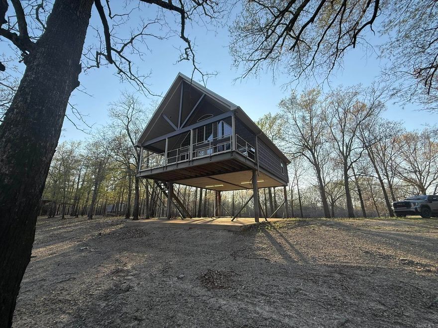 Elevated on hydraulic stilts on Bayou Des Arcnon is the waterfront cabin you are looking for. It is complete with a private boat slip and boat ramp leading into the bayou which is less than two miles to the White River. Half a mile down the road, you can also find Bayou Des Arc WMA, 14 miles to Raft Creek, and it is ten minutes to the town of Des Arc. This cabin is sitting on 4.6 acres that includes a pond as well. Inside you will find an open concept living space with two bedrooms, one bath, and windows that cover the wall facing the water. This location can be your home away from home where everything moves slower and you can enjoy life.