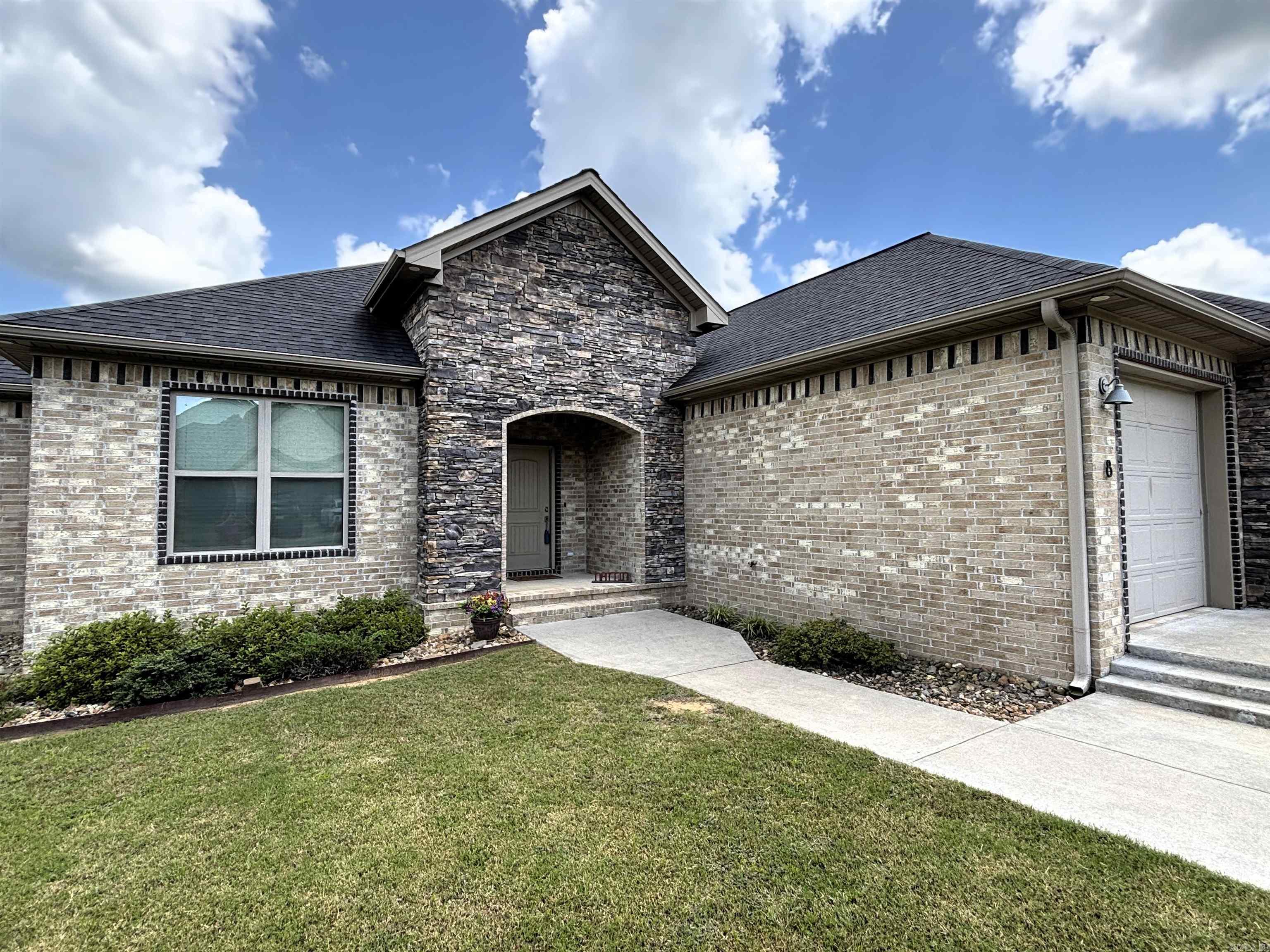Look at the all-brick home with eye-catching rock accents. Built in 2019. Its open concept with split floor plan offers an ideal balance of privacy and flow. Luxury vinyl plank flooring throughout the main living areas with tile in the wet areas. Three spacious bedrooms and two full bathrooms, this home offers both comfort and functionality. Closets everywhere! Low-maintenance privacy fenced yard with an extended patio off porch provides a great space for entertaining. Gated neighborhood for extra security.