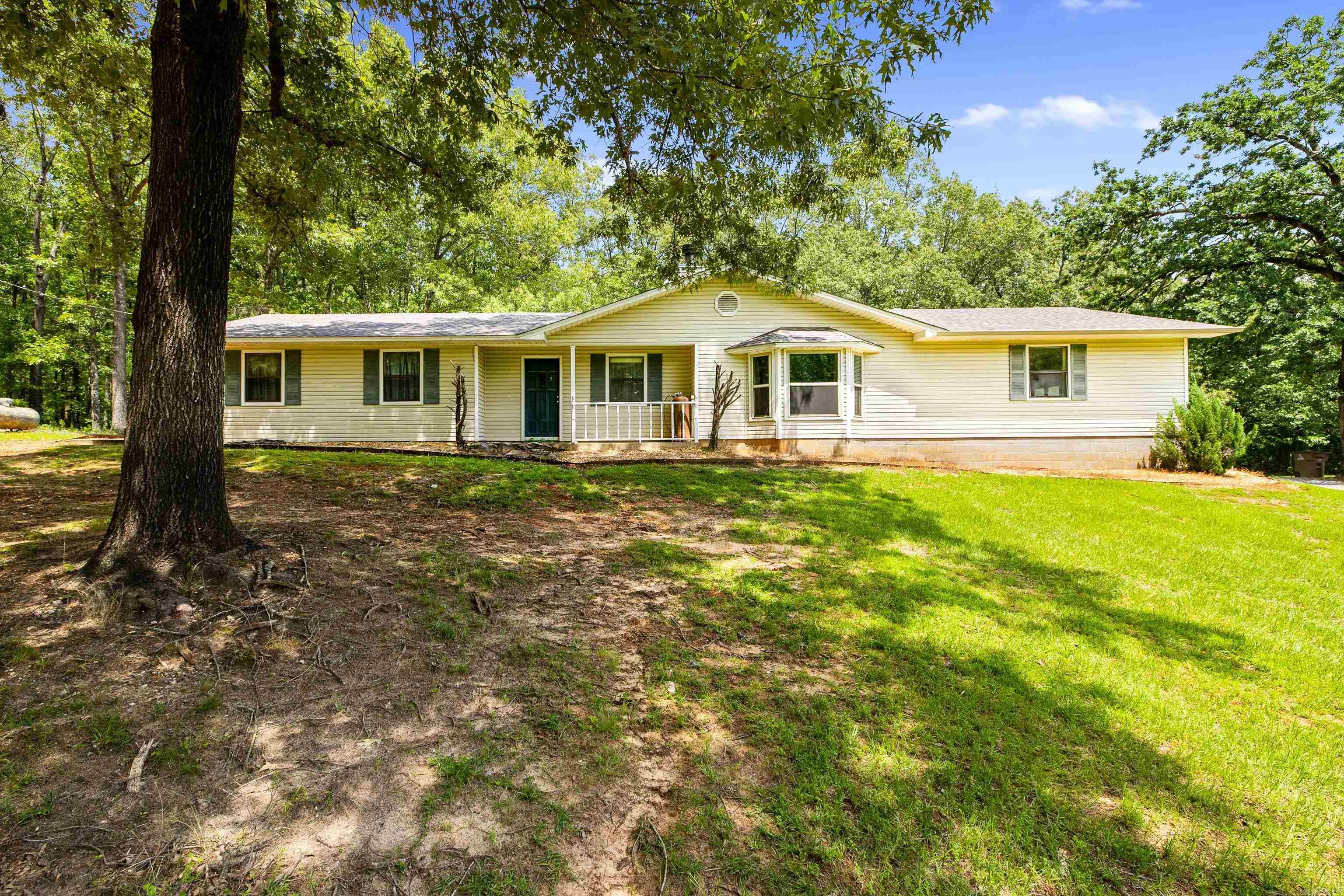 Just LOOK at this hidden gem!! Situated on 2 acres with an 18x36 in-ground pool with a slide ($75,000 in value!), 2 car garage with 3x8 underground storm shelter, a separate work shed, a carport for ATV's, and tons of privacy!!! What more could you want in a home?! Perfect for those who want to get away from it all while still being 20 minutes from downtown Little Rock. Yes, this home might need a *little* modernizing but guess what? Seller is offering concessions for paint, grass sod, or whatever YOU need to make it your own! The double-sided gas fireplace means you can entertain guests in one living area while the children run around in the separate living area - because yes, there are TWO living areas (or you can make one a formal dining, if you wish!). Eat-in kitchen, built-in shelving, this home has it all. Additionally, the gorgeous 2 acre pasture next door is owned by the same owner - please text agent for details on what that would go for, if interested.