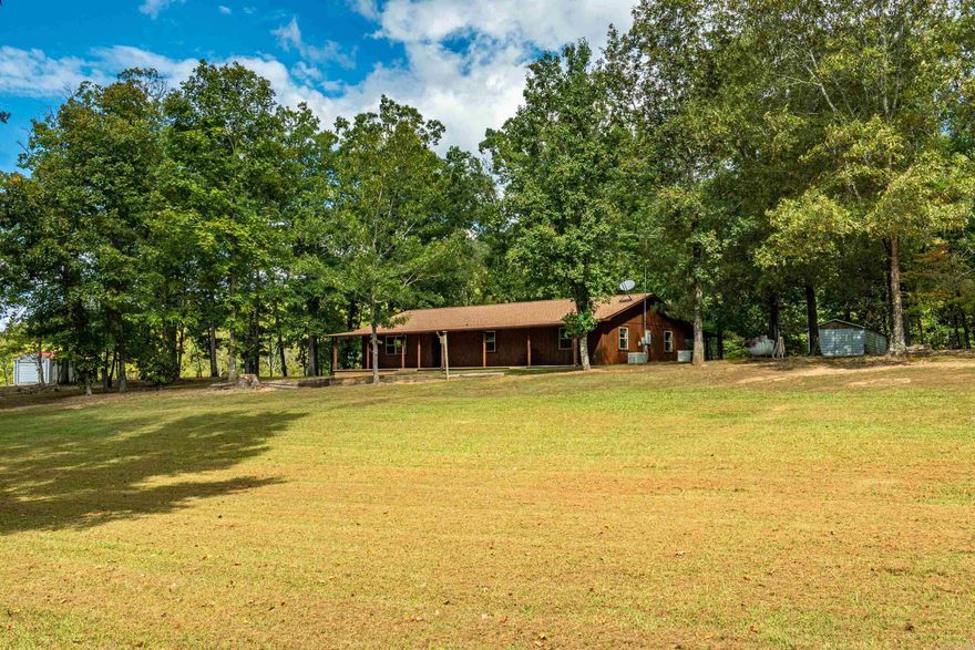 Charming Rustic Ranch with Mountain Views located in Lakeside School District!  Welcome home to this inviting 3-bedroom, 2-bathroom country retreat nestled on 3.32+/- acres just minutes from Lake Hamilton. With beautiful views of Jack Mountain and an abundance of deer and wildlife, this property perfectly blends rustic charm and natural beauty.  Step inside to find spacious living areas highlighted by warm knotty pine walls and timeless country character.  Enjoy the outdoors from the large front and back porches, or host the ultimate cookout under the metal pavilion, complete with plenty of room for entertaining. A 30x54 metal utility building with electricity provides excellent space for storage, hobbies, or a workshop, and there’s an additional 10x18 metal storage building for even more convenience.   Recent updates include new windows (2025),  exterior paint (2025), a roof only 2 years old, and a septic system cleaned in 2024—all adding peace of mind for the next owners. Includes generator for added convenience.  With its scenic views and thoughtful updates, this property offers the perfect blend of comfort and countryside living. SF via Tax Records-please feel free to measure.