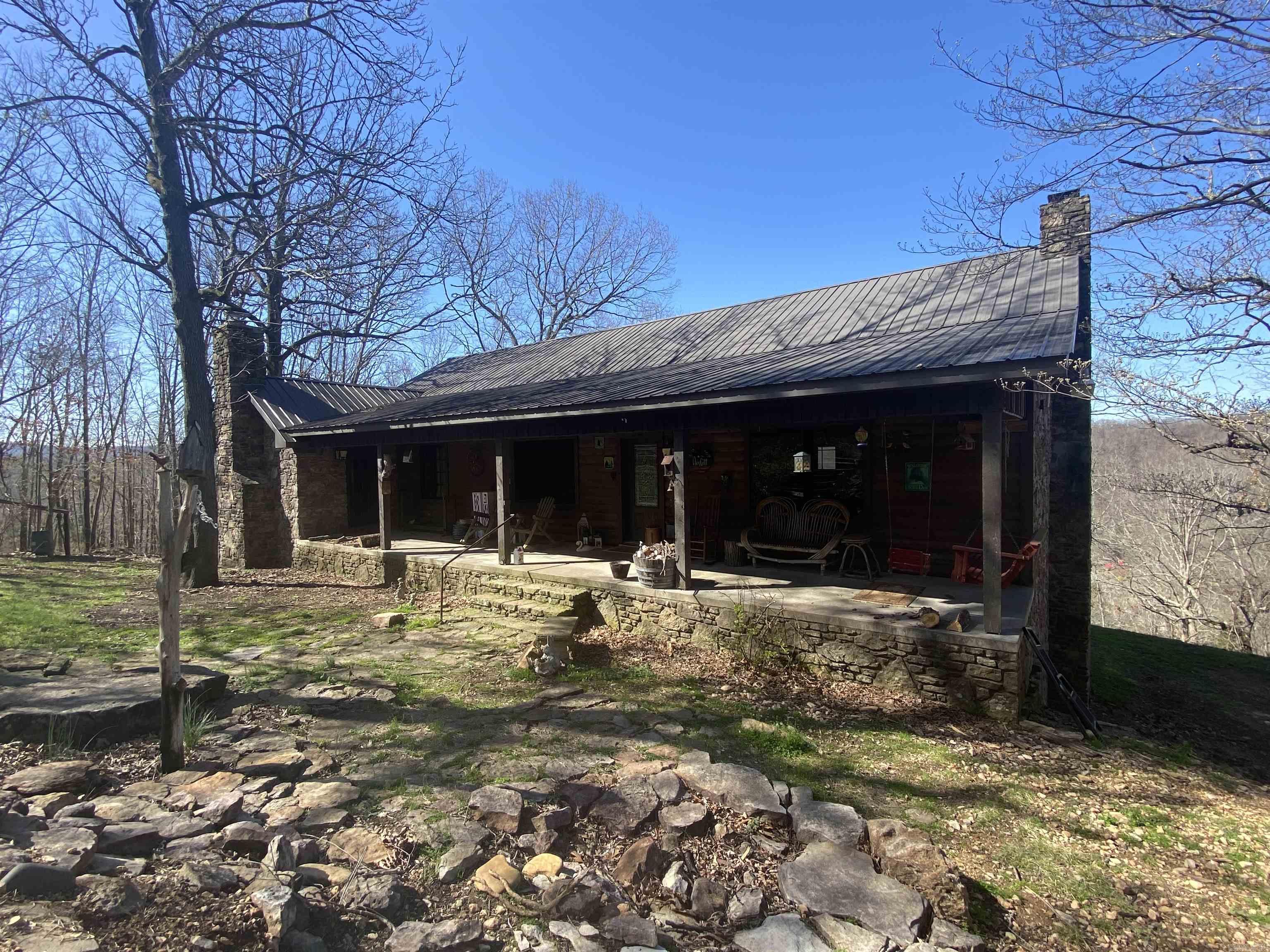 Welcome to this charming 4-bedroom, 3-bathroom house nestled in the serene landscape of the Ozark Mountains with a beautiful view of the Sylamore Creek Valley. As you approach, you're greeted by the sight of a picturesque exterior with a blend of rustic and modern architecture with native stone covering most of the home. As you walk in you will notice the spacious living room and cozy rock fireplace with a separate dining room and a world class kitchen with oak cabinets, granite countertops and a commercial stove with double ovens, warming rack and flat top griddle! This is a one of a kind kitchen that will make your gatherings stand out from the rest! Down the hall is the master bedroom and bath with a custom clawfoot tub and fireplace for when you want to relax in private. There is also another bedroom and bathroom on this same level. The basement is built for entertaining. There is an additional 2 bedrooms and bathroom in the basement and the basement bath is just as nice as the rest of the home with a claw foot tub and walk-in shower! Also, lets not forget the unfinished guest house that is waiting for your finishing touches. There is more to see so call today for a showing!!