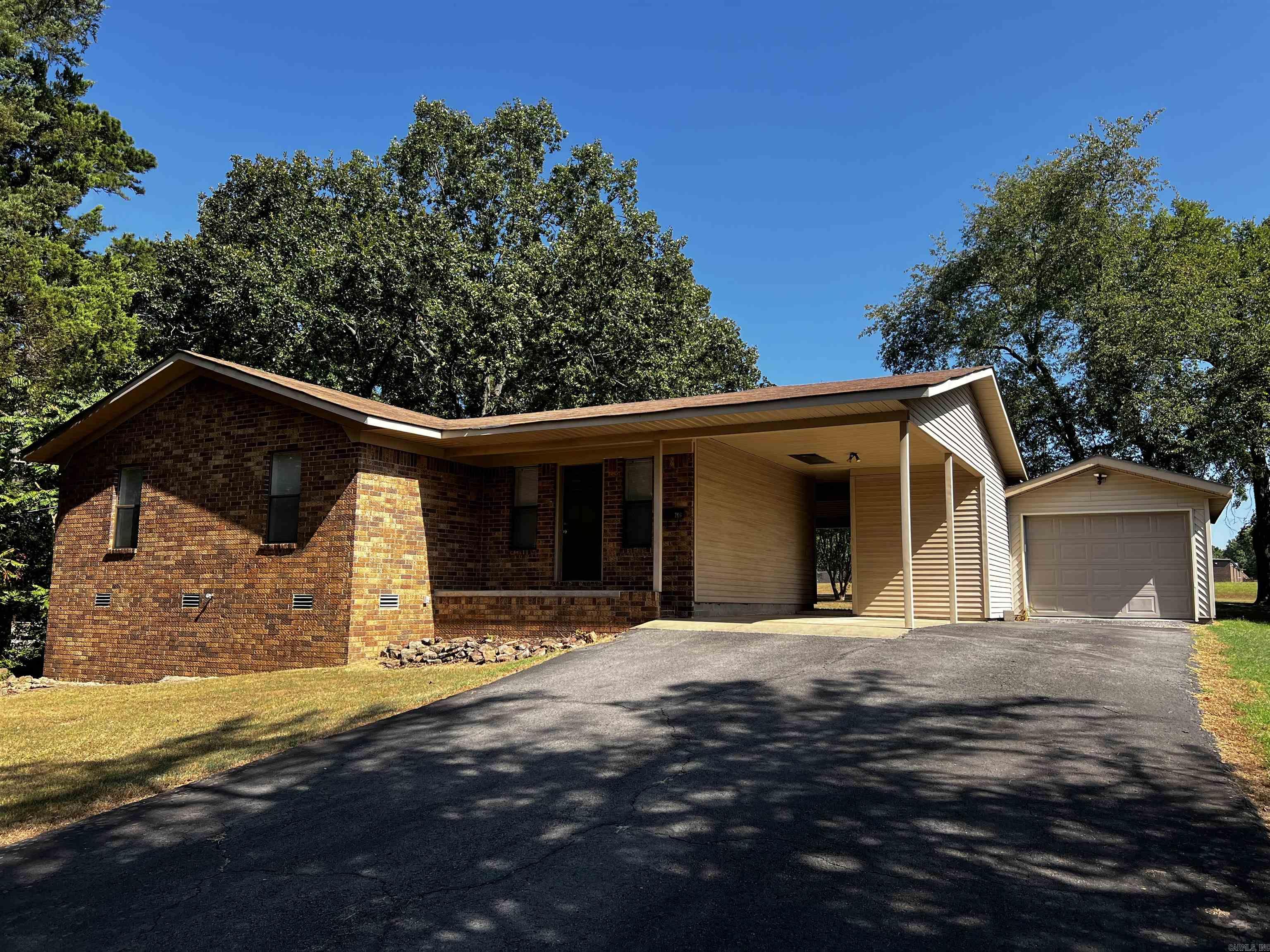 Updated and move-in ready 3 bedroom home on approx .67 acres, large covered private back porch with mature trees providing shade, back yard joins open field with room for kids and dogs to run, low maintaince brick and siding home, with carport and a single car garage, with outside storage, the primary bedroom is large enough for a king bed and has his and hers closets, open kitchen with a separate dining area and breakfast bar, home is near Heber Springs High School, updated in 2023 with new luxury vinyl, central HVAC, and hot water heater