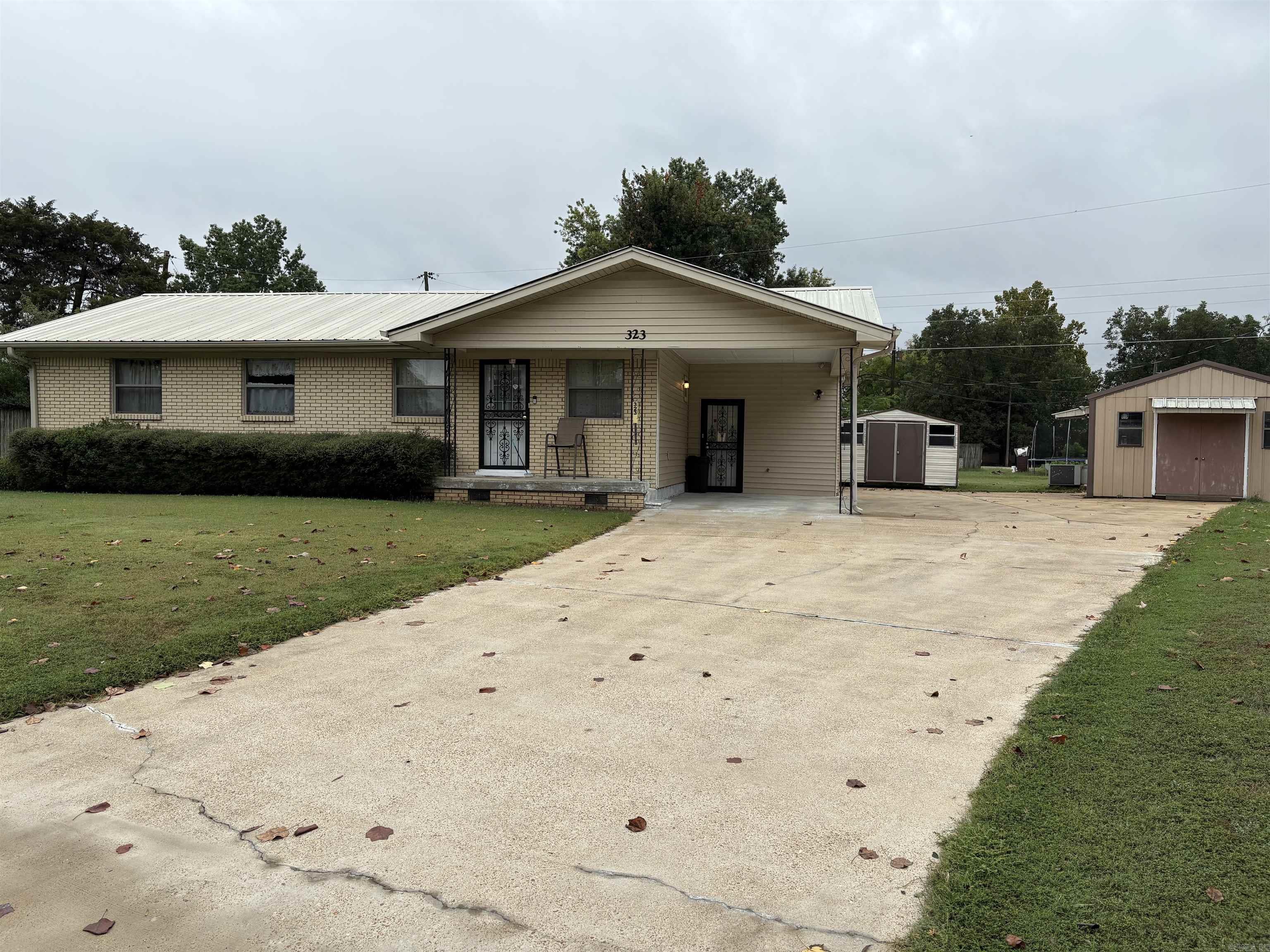 New to the market is this beautiful brick home sitting in a corner. This home features 3 bedrooms, 2 Bath, carport, storage building, workshop with a/c, screened porch and metal roof. Don’t wait too late!