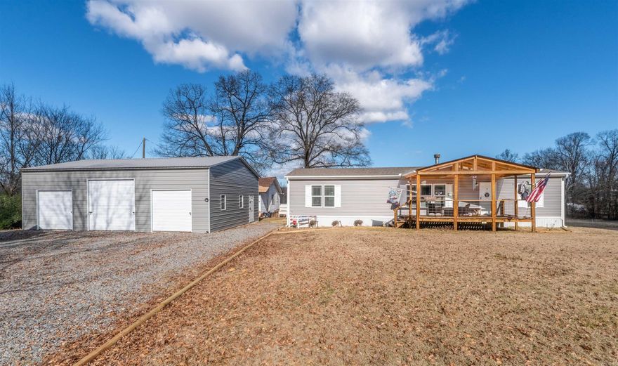 2023 manufactured home on a permanent foundation situated on approximately 10 acres +/- with no restrictions. This 1,600 sq ft home features an open floor plan with a real wood-burning fireplace, front porch, and back deck. Property improvements include a 30x40 detached shop/garage with 3 bays, 30x32 greenhouse, shed, and 3 chicken coops, offering endless possibilities for animals, hobbies, equipment storage, or homesteading. The property is fenced and cross-fenced and borders Greenbrier Creek for added outdoor enjoyment and scenic views. Primary bath features a 72-inch shower and soaking tub. The original approximately 900 sq ft home on the property conveys at no value and could serve as storage, workshop space, or potential additional living space with improvements.
