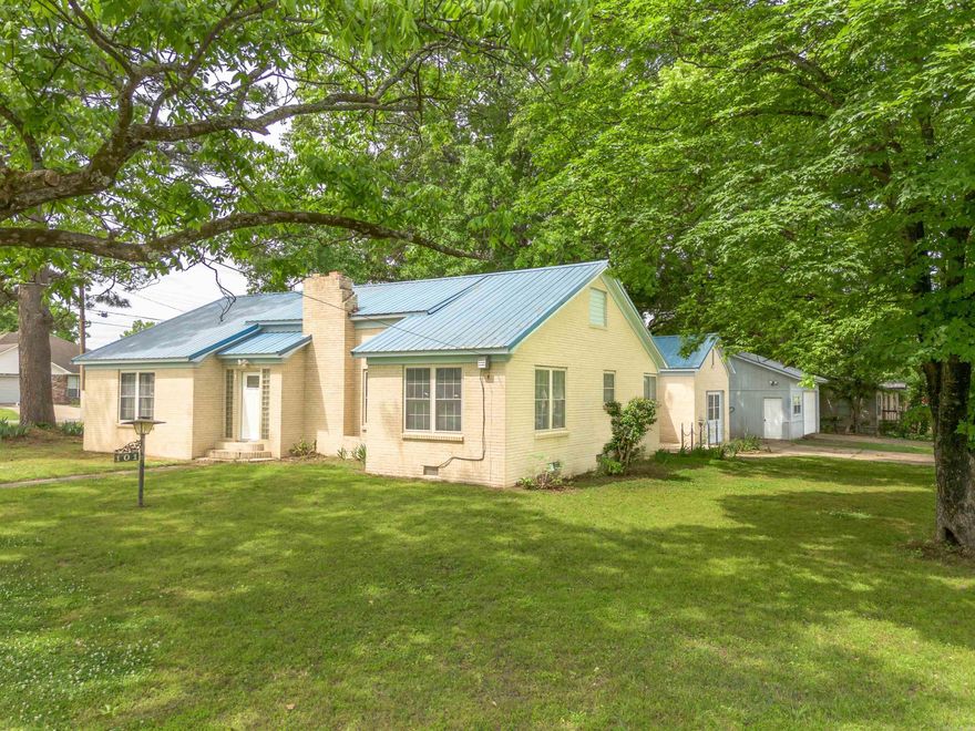 Solid brick home with metal roof featuring extensive 2026 renovations throughout. The kitchen has been fully remodeled with granite countertops, all new soft-close cabinetry, and new Frigidaire appliances, while the bathroom has been completely updated with new tile, fixtures, and cabinetry. Major improvements include all new plumbing, luxury vinyl flooring, fresh interior paint throughout, recessed lighting, updated fans and light fixtures, new doors, electrical outlets, and an electric fireplace heater. Built with older-growth materials, the home sits on a crawl space with heavy cypress wood support and offers cedar closets. Exterior features include two lots, a mature, productive pecan tree, garden space, a large shed (12' x 24'), and a two-car garage (24' x 30') with additional workshop space. Windows and the metal roof were both installed in 2014, and the home has been consistently maintained with major systems updated or recently serviced, including a gas water heater (2017) and HVAC system (2018, serviced 2026).