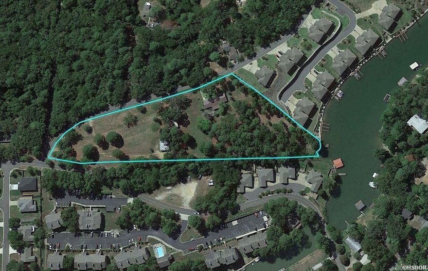 VERY RARE! Over 4 acres of land with 100'+ of frontage on Lake Hamilton!  The property includes a 3BR/2BA brick house and a 30' x 40' shop building, along with the original homestead barn dating back to the 1800s.  This property's location off Burchwood Bay Road is in the center of town and close to everything Hot Springs has to offer. The grounds are truly spectacular!  This would be the perfect location for an equestrian estate on Lake Hamilton or even a garden home development.  Pictures don't do it justice - must see in person.