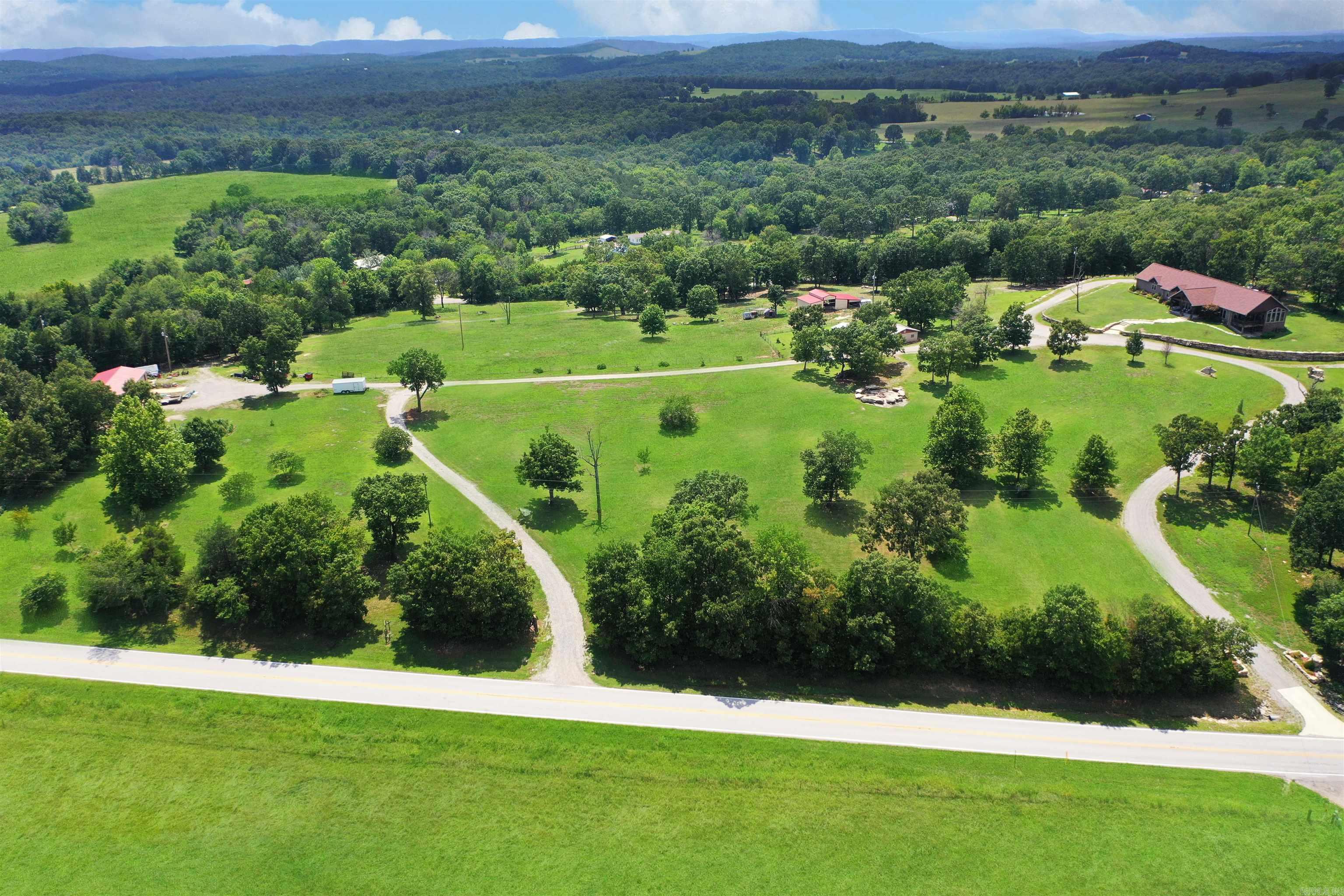 Unbelievable views. Custom built 4 bedroom, 3 bath, single level, 2 car garage with over 3,000 sq ft home. Cathedral ceilings in living room, sunroom and 9 ft ceilings in the remainder of the house. Move in ready mini/hobby farm with readymade garden, 46ā x 25ā barn, loafing sheds, chicken coops, and 1,800 sq. ft. shop with 2 - 12ā x 11ā roll up doors. Over 25 acres, including 18 acres m/l of web wire fencing and cross-fenced with 5 separate pastures and spring fed pond. Guest/party house with over 1,000 sq ft and ācook shedā has over 500 sq ft for entertainment. One-of-a-kind fire pit. Chain link fenced dog run. Apple, peach, pear, cherry and nectarine trees. Large rocks were brought in and strategically erected on 3 sides of the house which accents this property uniqueness. Great location just minutes from town, 2 lakes and 3 rivers. Donāt miss out on this fabulous listing. Also, contains parcel #002-09566-004.