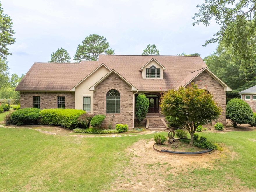 Luxury Living in Lotus Valley Subdivision! This 2 story 3/2.5 home welcomes you into a grand living room space with high ceilings and a beautiful rock fireplace that creates a welcoming atmosphere.  The spacious kitchen is a chef's dream, featuring high-end appliances, granite countertops, and an island perfect for meal prep and entertaining. The large master suite features lots of natural light, hardwood floors and it opens up to a luxurious bathroom with double vanity sinks, step-in shower, a relaxing jacuzzi tub, 2 closets and a wall full of extra storage space. The downstairs is completed with a utility room that includes a dedicated dog wash station, ideal for pet owners a a large office. The 2-Car Garage also comes with an additional workroom, perfect for DIY projects and storage. On the upper level are 2 additional spacious bedrooms that each have their own full bathrooms, ensuring comfort and convenience for all residents.  There is also a seating area providing a cozy area for reading or relaxation.  This stunning home offers luxury, comfort, and ample space for all your needs. Contact me today to schedule a viewing and experience the epitome of upscale living!