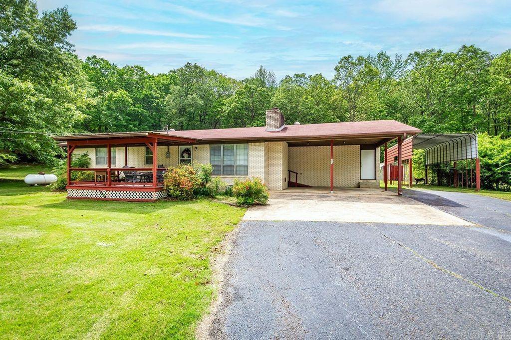 Beautiful brick 3 bedroom, 2 bath home on one acre. All new appliances and new flooring, Home features a front porch and back covered deck for mornings and evenings. Nice lawn. Storm shelter, storage shed and a RV carport.