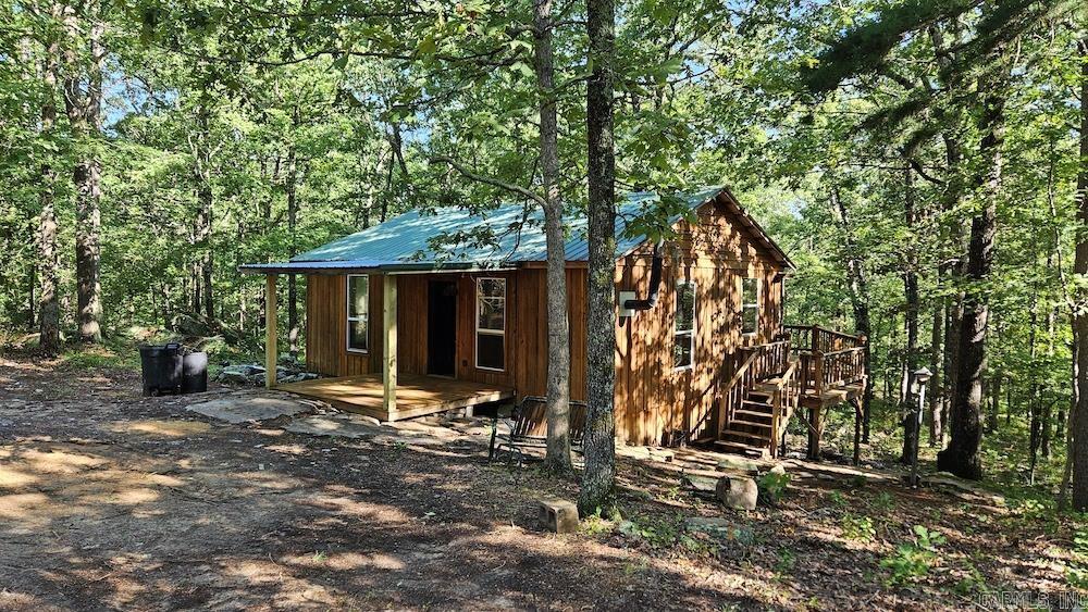 You can’t miss this special cabin on some amazing hunting land full of character, raw Ozarks beauty, and seclusion. Laying in some remarkable rolling terrain, the cabin is super private and accessed by a deeded easement. Recently remodeled, this thing is ready for you to come put your finishing touches on it. The 2 bedroom/1 bathroom cabin has new lighting, some updated electrical and plumbing work, some new flooring, a completely new bathroom, new appliances, cleaned from top to bottom, new ceilings, new mini split heating and cooling, and more. The massive deck covers the back of the cabin, overlooking a serene wooded flat, and is partially covered. Being built partially on a massive boulder, it is both sound and solid. There is also fiber internet, so no matter if you are hunting, vacationing, or just getting away… you can always stay in touch with business or family. This picturesque setting has to be seen to be fully appreciated. The tract is comprised of mature and marketable hardwood timber and is absolutely beautiful. Mainly consisting of White Oak, Red Oak, Post, and Hickory, you will not believe the stand of timber this property possesses.