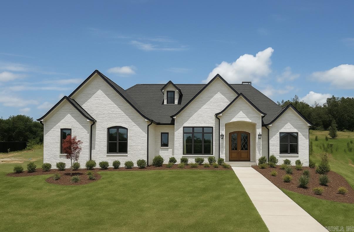 LAKE HAMILTON VIEWS ABOUND IN THIS NEW CONSTRUCTION HOME IN GATED COMMUNITY JUST MINUTES FROM OAKLAWN! Step inside to soaring spaces filled with natural light, an inviting living room with built-ins and a gas fireplace, and an open kitchen featuring a quartz island, breakfast bar, huge walk-in pantry, and expansive dining area. The primary suite is a showstopper with cathedral ceiling, spa-worthy freestanding tub, custom tile shower, and a massive walk-in closet that connects to the laundry room. A stunning office with 12-foot ceilings, French doors, and incredible lake views makes working from home a dream. Upstairs offers a versatile bonus room or bedroom with full bath and private balcony overlooking the water. Enjoy outdoor living with a covered porch and outdoor kitchen, plus a 3-car garage, mudroom, and private neighborhood boat launchāall with hardwood floors, designer lighting, and top-tier finishes throughout. Estimated completion October 2025, still time to pick some finishes!