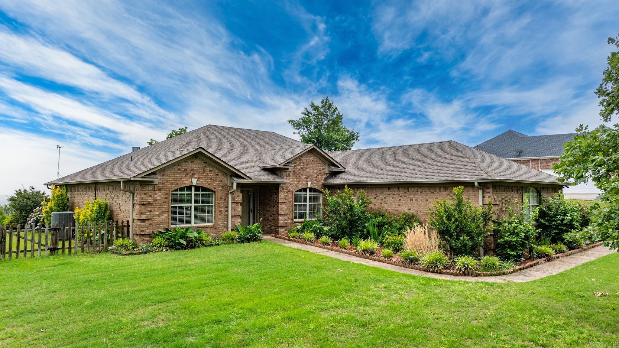 What an incredible view! This stunning one-story home is perfectly positioned on a 1.1-acre lot and offers sweeping panoramic views from the oversized back deck—ideal for entertaining or simply relaxing in the peaceful surroundings. Located in the highly desirable Conway School District with quick access to I-40, this home features a split floor plan and is completely wheelchair friendly, offering both functionality and privacy. Inside, you'll find 3 spacious bedrooms and 2 full bathrooms across 2,088 square feet of well-maintained living space. Cozy up next to the gas fireplace in the inviting living room, and enjoy the well-appointed kitchen. The property includes a climate-controlled 20x30 detached garage that offers additional square footage for hobbies, storage, or a workshop. A fenced-in area on the north side of the home is perfect for kids or pets to play safely. Notable upgrades include a new roof (2017), hot water heater (2015), a SEER HVAC system (2015) and solar panels that cover the entire electric bill! With breathtaking views, generous outdoor space, and convenient location, this home truly has it all.