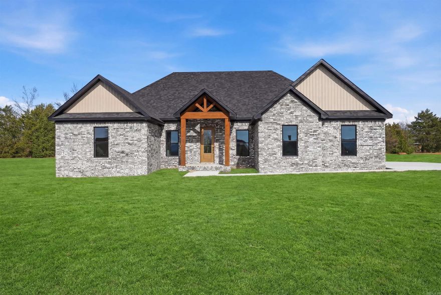 Welcome to your dream lake home retreat—new construction with premium materials and refined finishes, tucked inside an exclusive gated community! Located ~10 minutes from Shiloh Marina on Greers Ferry Lake, this 4 bed, 2 bath home offers 2,200 sq ft of stylish and functional living space. Enjoy custom cabinets, granite countertops, a double oven, and durable LVP flooring throughout. The spacious living area features an electric log fireplace, perfect for cozy evenings.  Step out back to a large covered patio with a gas hookup—ideal for grilling and entertaining. Energy-efficient upgrades include a gas tankless hot water heater, radiant barrier roof sheathing (keeping the attic ~30° cooler than standard roofing materials), and Class 3 impact shingles, which offer added durability during high winds & hail as well as insurance savings.  Set in a gated neighborhood with a private boat launch, this home combines comfort, quality, and lake living at its best! Schedule a showing soon & be the first to own this stunning home!