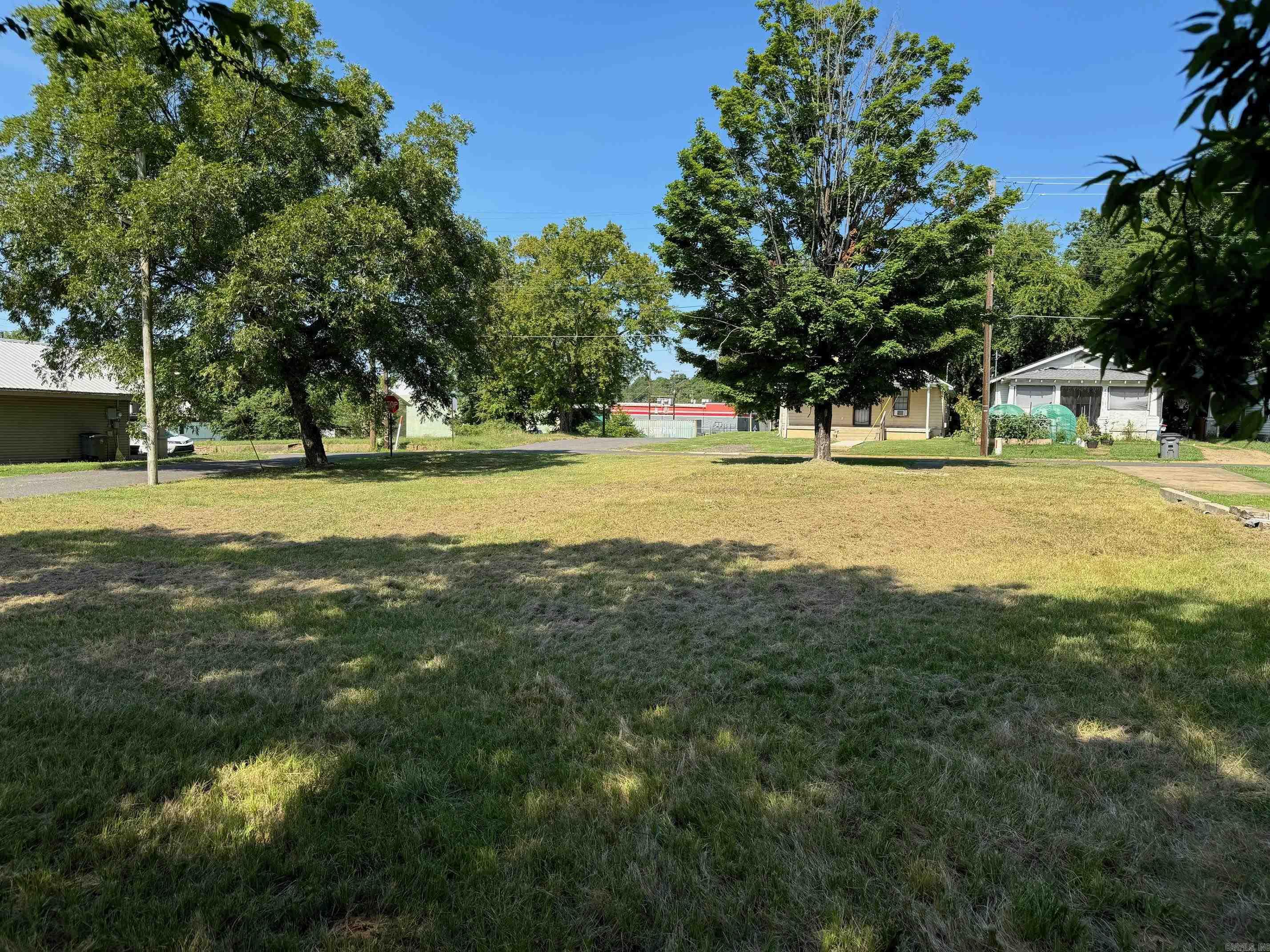 This spacious 10,875 sq. ft. lot (per ACTDataScout records) is zoned R4, making it a great opportunity for development. City zoning requires a minimum of 8,500 sq. ft. to build a duplexābuyer to verify with Hot Springs Planning & Zoning. The property includes a 21' x 17' garage with a new roof, trusses repaired, plus covered storage in the back. The garage could serve as a workshop or a maintenance shed for a future duplex. Don't miss this versatile investment opportunity!