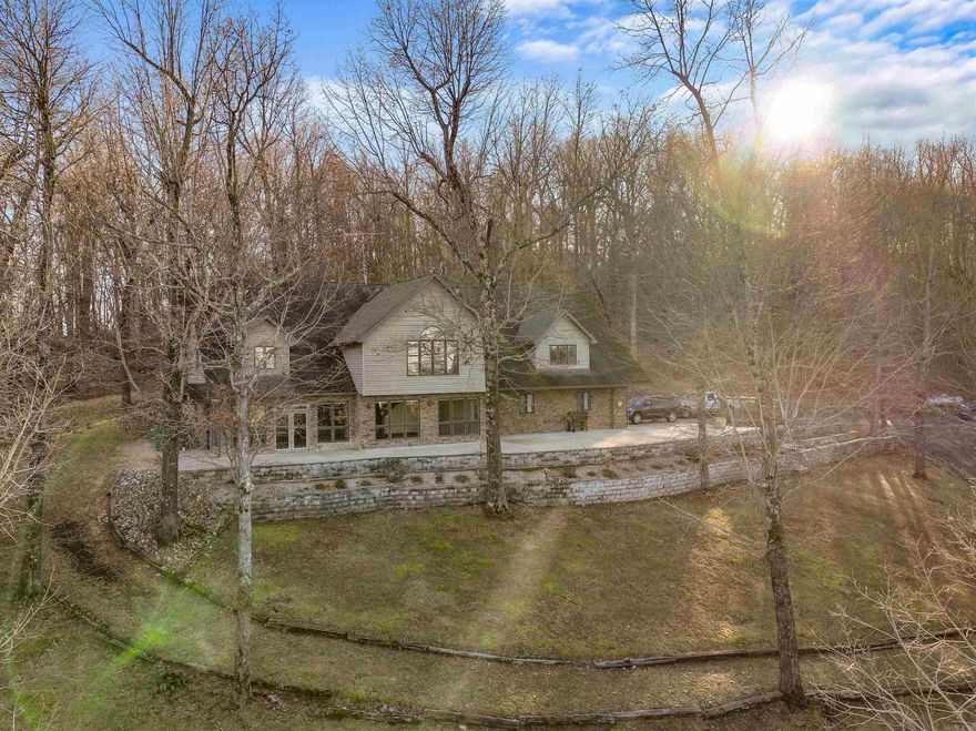 Welcome to your new retreat, a sprawling 4,900 sq ft haven nestled on the outskirts of the enchanting Ozark National Forest and bordering the National Forest as well! Positioned moments from premier fishing spots along the White River and Norfork Lake, this residence offers captivating panoramas of the distant White River, inviting you to immerse yourself in its allure. Step into the heart of this abode to discover a chef's dream kitchen with high-end commercial-grade cooktops and double ovens, seamlessly blending into the expansive living area. Ascend to the upper level, where a versatile bonus space awaits, perfect for creating a secondary living area tailored to your needs. The Master Suite features built-in dresser cabinets and two walk-in closets. Whether you're passionate about boating or RVs, ample accommodations await with the sprawling shop featuring RV parking and hookups for three vehicles, all set within 12.38 acres M/L. Come and experience serene living!