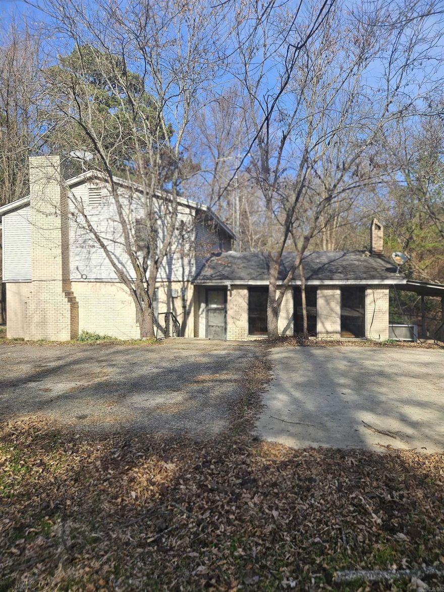 Spacious 4BR/2BA home offering over 2192 sq ft of comfortable living space, conveniently located within minutes of Saratoga Landing for excellent fishing and lake access.  The main level features two generous living areas, including a cozy den with fireplace and a separate large living room perfect for entertaining or relaxing. The kitchen offers apple cabinetry, a breakfast bar, and convenient pantry located beneath the staircase.  Upstairs includes three bedrooms and one full bath, with a peak of the lake from the primary bedroom deck.  The fourth bedroom and second full bath are located on the main level, ideal for guests or a home office.  Outdoors include a covered deck area, extra parking, storage building with an adjacent dog kennel, and a separate fenced in area that could be used for a great garden spot.  The home does need a little TLC, making it a great opportunity for buyers to add their own personal touches and build instant equity.  With its quiet setting, lake views, and generous space, this property would make a great relaxing lake retreat.