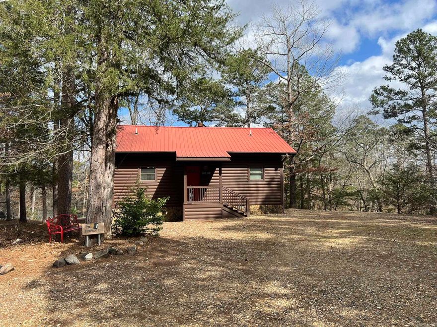 Escape to your own private slice of paradise on the breathtaking Mountain Fork River! Whether you’re dreaming of a peaceful getaway, a full-time retreat, or an income-producing vacation rental — this one checks every box. Crafted with Douglas fir log siding (newly stained cedar in 2023), rich red cedar trim, and topped with a durable metal roof, this cabin blends rustic beauty with lasting quality. Built in 2006, this charming 1-bedroom, 1-bath has so much storage, all thoughtfully placed. Double electric fireplace in the living and bedroom, which has two large closets and a jetted tub. Start your mornings or wind down your evenings on the covered, screened-in porch overlooking the river. Prefer grilling and gathering? The deck offers stunning water views! Take the steps down to the lower deck with built-in seating or enjoy the picnic tables and swing near the fire pit. 307 feet of river frontage on a wide, scenic stretch of the Mountain Fork...there is a perfect place to put in a kayak. Two storage buildings, all furnishings and appliances included, water softener, Marathon water heater, tiled shower - you have to see this! Plenty of room on the land for more cabins or a home!