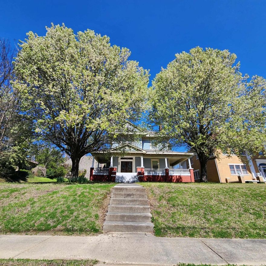 Known as the Blue House on the Hill (1 mile from the Mississippi River) - Currently a unique themed room lodging; private short-term rental, full second floor, Airbnb. This large home has front, back, & side entrances. Situated above street level, fenced in backyard, 2 off street parking areas, fresh paint, high ceilings, vintage trim, large rooms, hardwood floors, tile, & cork flooring. Downstairs has a wet bar & a main kitchen, step in shower, 2 stairways to 3 bedrooms & 2 baths, plus a laundry/kitchenette area. There is a wraparound porch on 3 sides, separate heating & cooling for up & down stairs, tankless water heater, new refrigerators & microwaves, whole house generator hook up, large walk-up attic that could be finished out. Most of the furnishings convey. Side entrance leads to upstairs that could be used as multifamily residence.  New dehumidifier in basement, keypad entry locks, shower, tankless water heater, whole house generator, laundry sink, bath sink, cabinets. Updates include: painting, plumbing, tile floor, brick foundation repairs. *No Owner Financing & No Rent to Own*