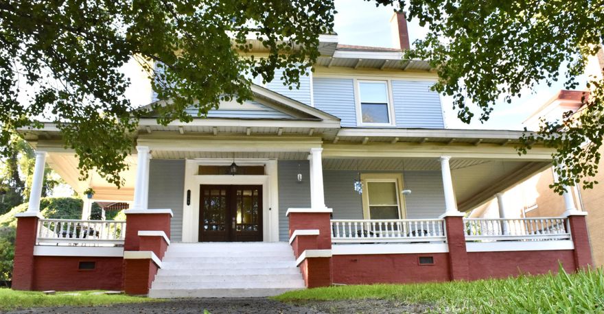 Known as the Blue House on the Hill (1 mile from the Mississippi River) - Currently a unique themed room lodging; private short-term rental, full second floor, Airbnb. This large home has front, back, & side entrances. Situated above street level, fenced in backyard, 2 off street parking areas, fresh paint, high ceilings, vintage trim, large rooms, hardwood floors, tile, & cork flooring. Downstairs has a wet bar & a main kitchen, step in shower, 2 stairways to 3 bedrooms & 2 baths, plus a laundry/kitchenette area. There is a wraparound porch on 3 sides, separate heating & cooling for up & down stairs, tankless water heater, new refrigerators & microwaves, whole house generator hook up, large walk-up attic that could be finished out. Most of the furnishings convey. Side entrance leads to upstairs that could be used as multifamily residence.  New dehumidifier in basement, keypad entry locks, shower, tankless water heater, whole house generator, laundry sink, bath sink, cabinets. Updates include: painting, plumbing, tile floor, brick foundation repairs. *No Owner Financing & No Rent to Own*