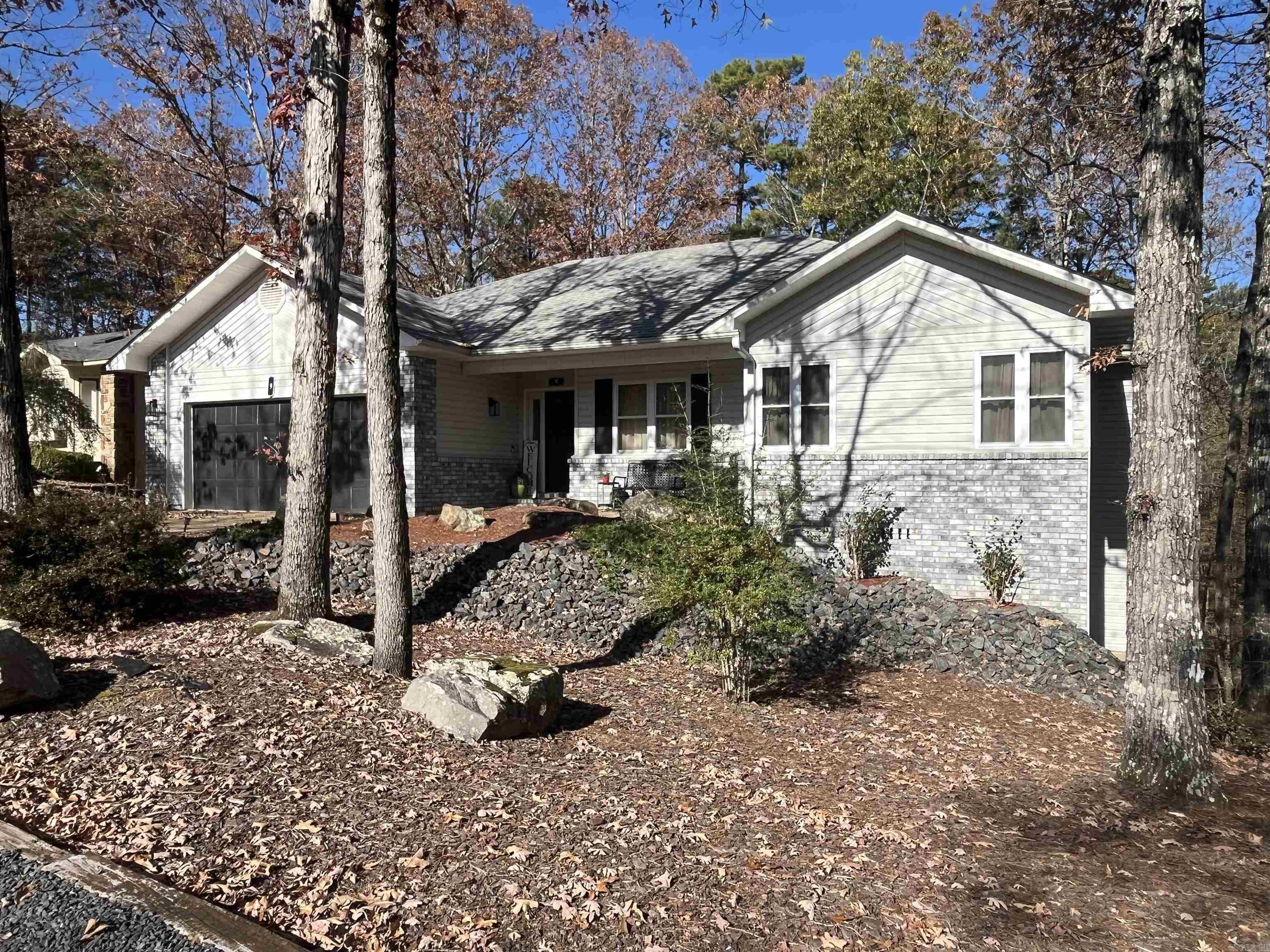 Discover your dream home in the heart of Hot Springs Village. This delightful 3 bedroom 2.5 bath home offers the perfect blend of comfort and style, nestled within a serene community that is known for its natural beauty and vibrant lifestyle. An open concept living space filled with natural light that makes it perfect for entertaining or enjoying some quiet time to yourself. The well-appointed kitchen boasts stainless steel appliances, a new compost/granite farmers kitchen sink, ample cabinet space, and plenty of work space for the cook in the family. Relax in generously sized bedrooms, including a master suite with an updated en-suite bathroom. If you don’t need the 3rd bedroom space, there is a perfect office setup in front bedroom where any business you need to attend to can be taken care of. Wait there is more! Extra bonus area downstairs perfect for an additional bedroom or make it a work out room! Many updates throughout - new roof in 2017, new HVAC system 2022, updated flooring, updated utility room and updated fixtures throughout! Don’t let this gem get away!
