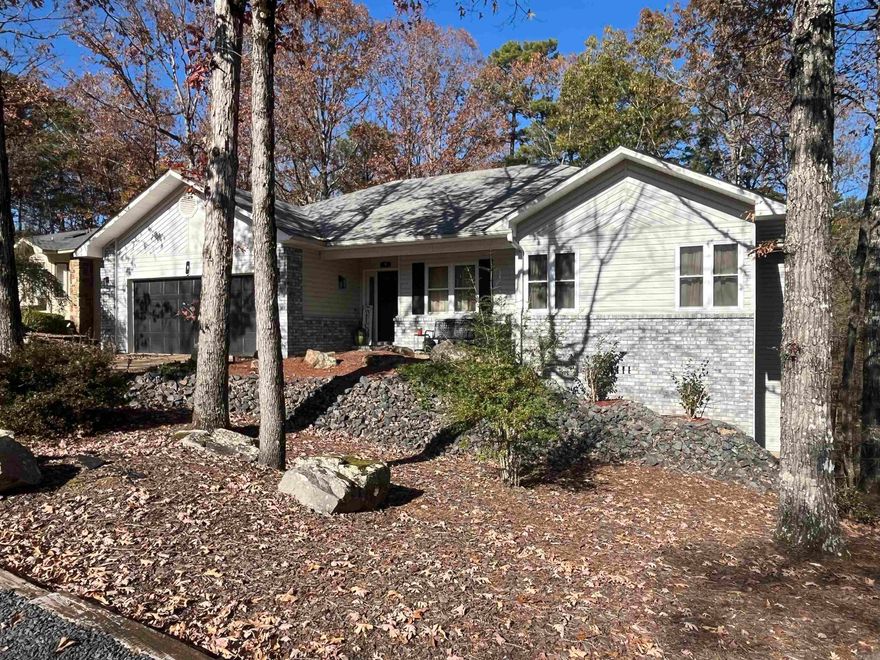 Discover your dream home in the heart of Hot Springs Village. This delightful 3 bedroom 2.5 bath home offers the perfect blend of comfort and style, nestled within a serene community that is known for its natural beauty and vibrant lifestyle.   An open concept living space filled with natural light that makes it perfect for entertaining or enjoying some quiet time to yourself. The well-appointed kitchen boasts stainless steel appliances, a new compost/granite farmers kitchen sink, ample cabinet space, and plenty of work space for the cook in the family.   Relax in generously sized bedrooms, including a master suite with an updated en-suite bathroom. If you don’t need the 3rd bedroom space, there is a perfect office setup in front bedroom where any business you need to attend to can be taken care of.   Wait there is more! Extra bonus area downstairs perfect for an additional bedroom or make it a work out room!  Many updates throughout - new roof in 2017, new HVAC system 2022, updated flooring, updated utility room and updated fixtures throughout!  Don’t let this gem get away!