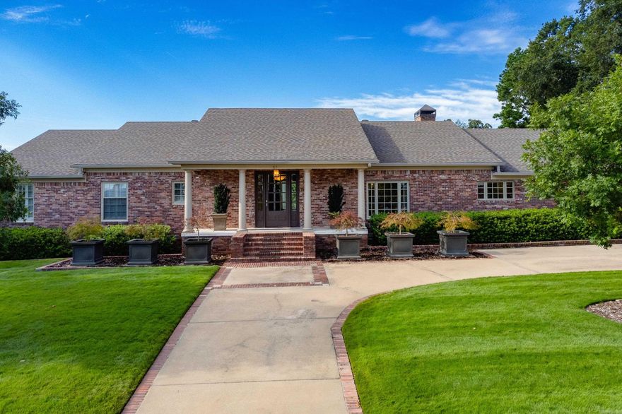 Welcome to this exquisite home providing a serene setting on large 1+acre lot. Charming front porch leads into an elegant foyer with marble floors. Hardwood floors flow into the large formal dining and formal living area bathed in natural light from large windows. Family room features parquet floors, a cozy fireplace, and French doors that open to vaulted screened-in sunroom overlooking huge yard. The light filled eat-in kitchen is a chef's dream with top of the line appliances, huge island with prep sink, custom cabinetry with appliance garages, and huge walk-in pantry and utility rooms. The primary suite is a true retreat offering a massive space with a sitting area, closets and built-ins. Luxurious bath features floating back to back vanities and large walk-in shower. Also on the main level is an in-law suite with handicapped accessibility, guest bedroom that could also serve as home office and another well appointed guest suite. Lower level features spacious bonus/game room with walk out access to backyard, guest bedroom and newly renovated guest bath. So much more! Come See!