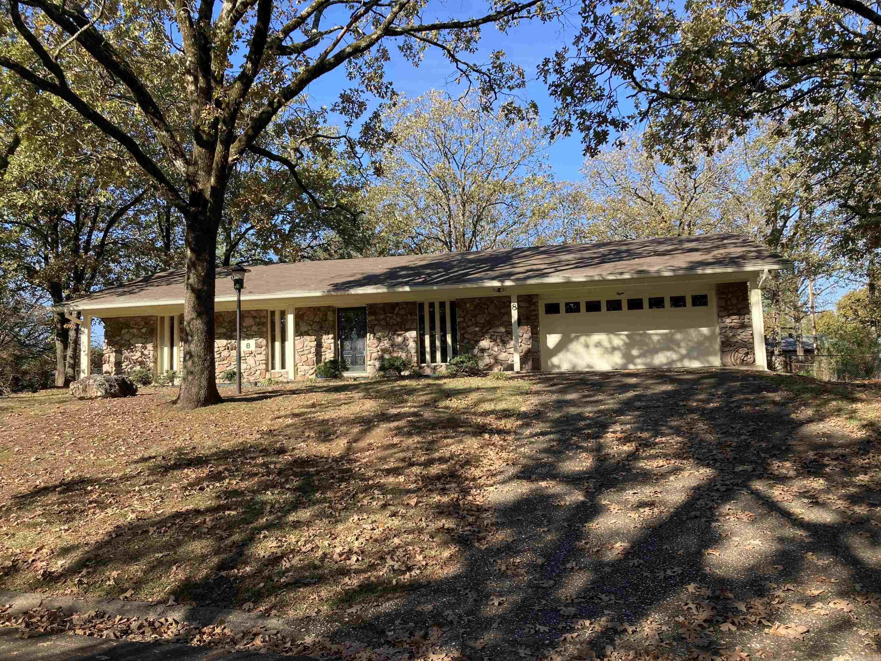 Situated on great, one block street, this mid century modern boasts lots of updates while maintaining many period features. Family room with natural stone fireplace/ hearth opens nicely to kitchen/ dining area. Tiled kitchen features granite counters, updated appliances, painted cabinetry, and pantry. Extra living/ study area or game/ play room. Spacious master suite with full bath. New luxury vinyl plank flooring and interior paint. Tiled baths feature granite vanity tops. Utility room with work sink and is large enough for freezer. Good closet space and storage thru-out including partially floored attic and garage shelving. Large front porch, plus rear patio. Stone/ freshly painted cedar exterior. Replacement vinyl windows, updated roof. Fenced, shaded backyard. Put your landscaping skills to work in your natural rock outcropping flower bed!